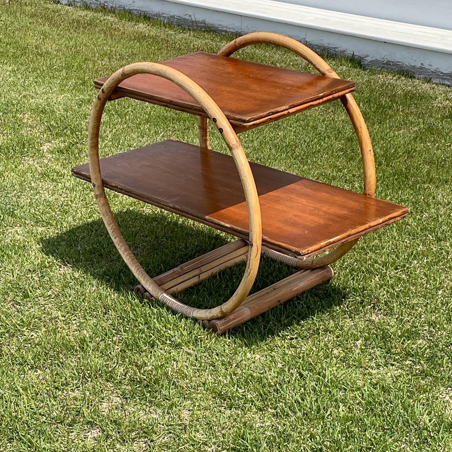 Round bamboo side table with two wood shelves . Can be a handsome bar , book shelf or just a lovely side table in your living space. . 