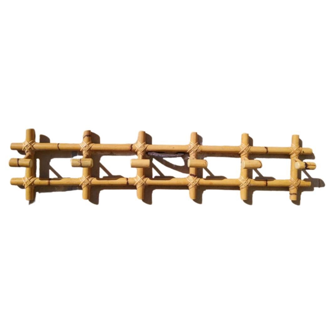 Bamboo coat rack with 6 hangers in natural color and elegant shape.

This midcentury bamboo coat rack is unusual - due to its size, elegance, a good coat rack for almost any space, whether exterior or interior.
It is in perfect condition and has