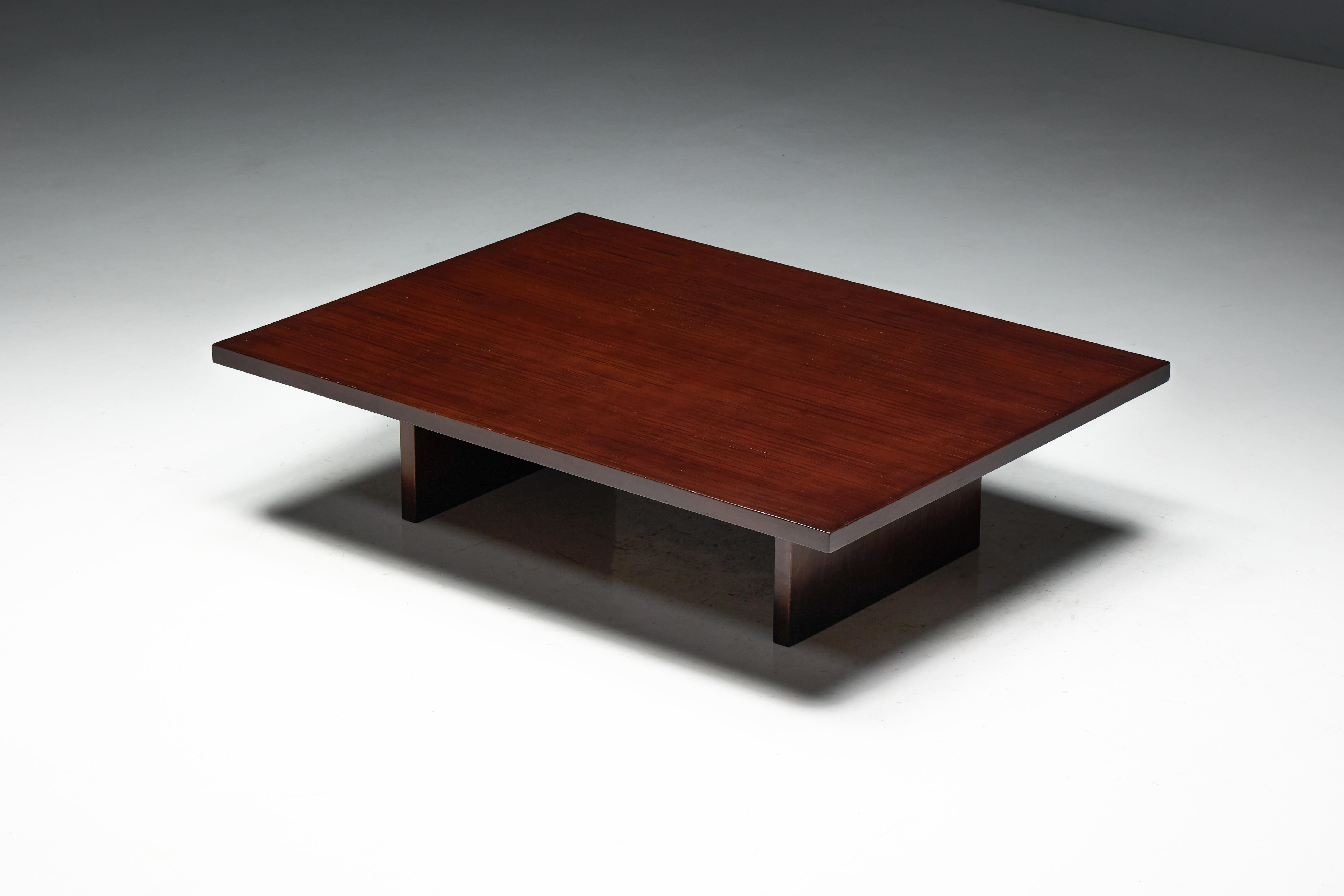 This striking coffee table, designed by Axel Vervoordt in the 1980s, exemplifies his mastery of understated elegance and natural materials. The broad, flat top is crafted from bamboo, arranged in a rich, textured pattern that enhances its organic