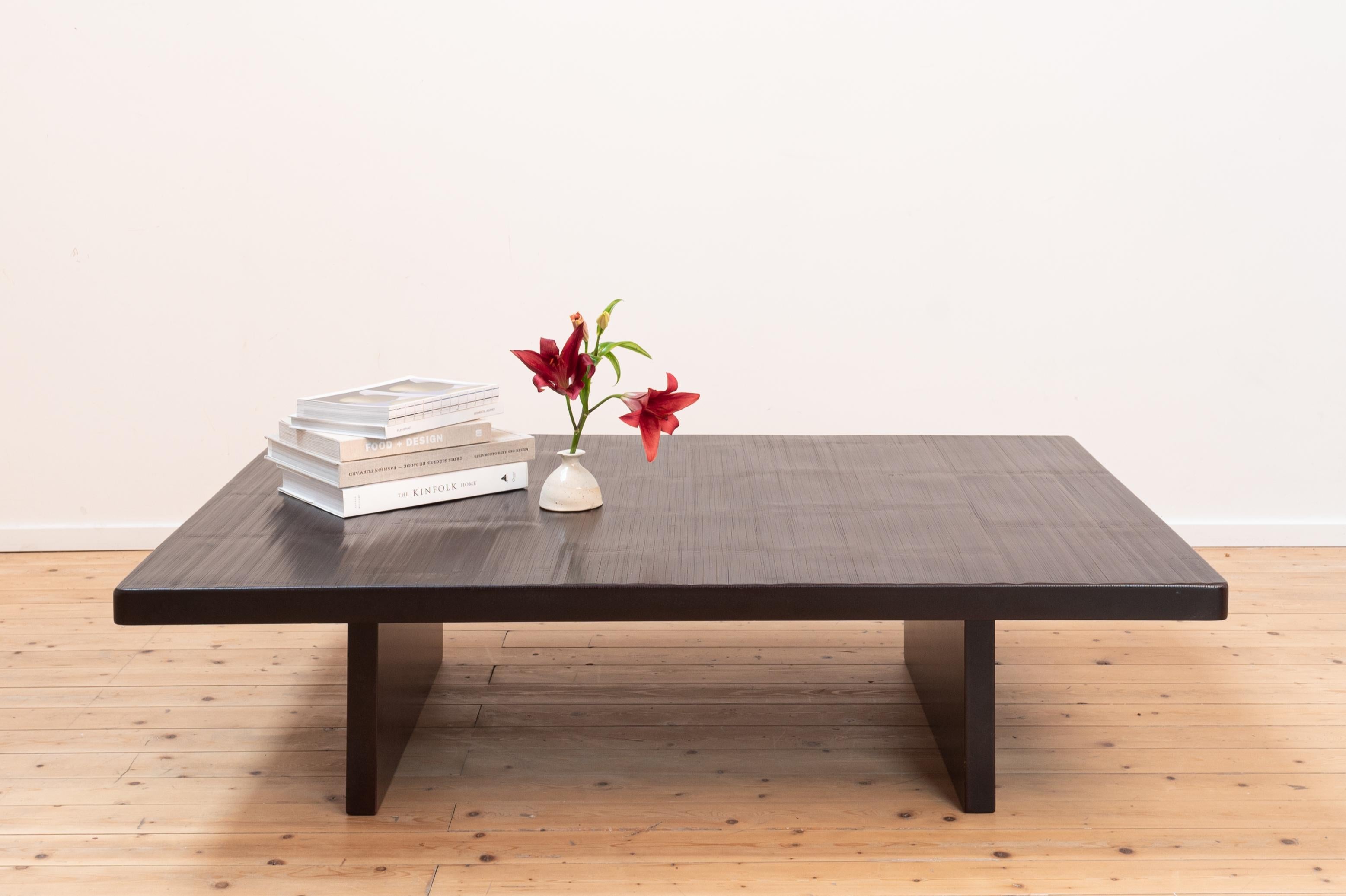Conceived and produced by the Belgian decorator & art dealer Axel Vervoordt in the 1980s. Rolls of bamboo were ordered in China to cover these specially designed coffee tables. 

Through this rather early career piece you can see Axel's eye for