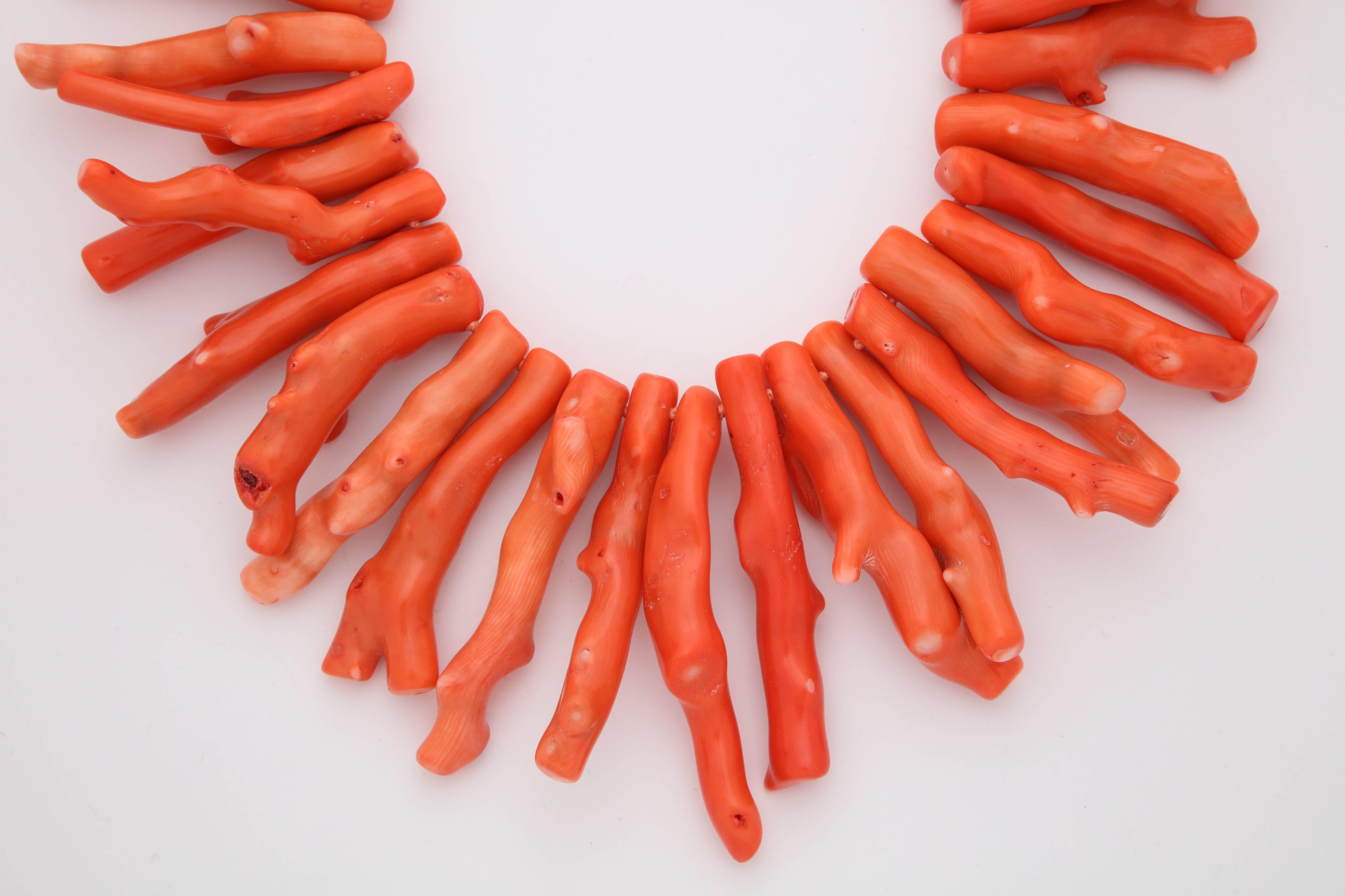 A necklace composed of dyed bamboo coral branches and a sterling silver clasp.  

Length: 17.50 inches