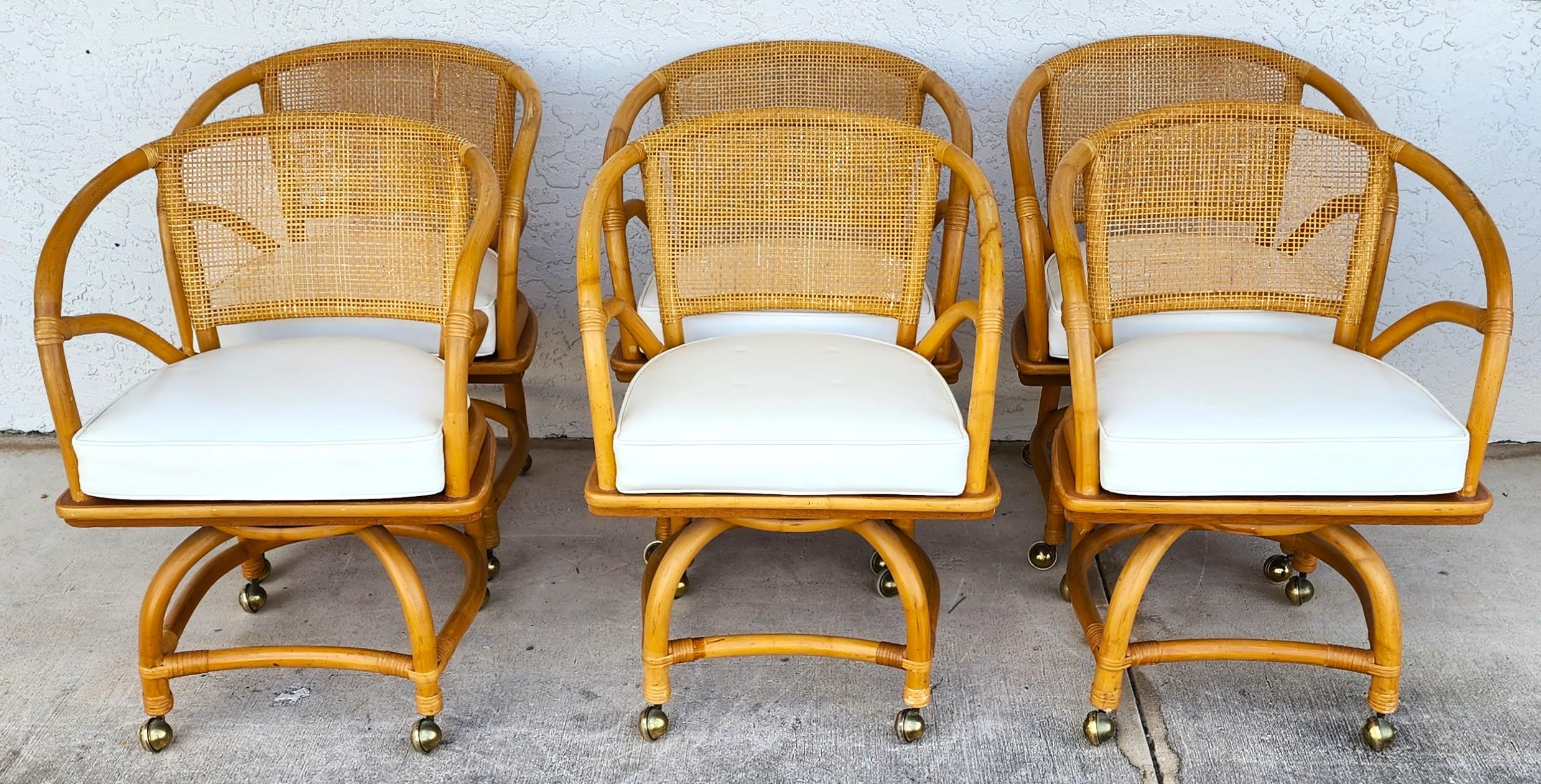 Offering One Of Our Recent Palm Beach Estate Fine Furniture Acquisitions Of A
Set of 6 1970s Bamboo Cane Back & Rattan Dining or Game Chairs with Swivel & Rolling by FICKS REED.
Includes reversible Vinyl air-cushioned seats.

Approximate