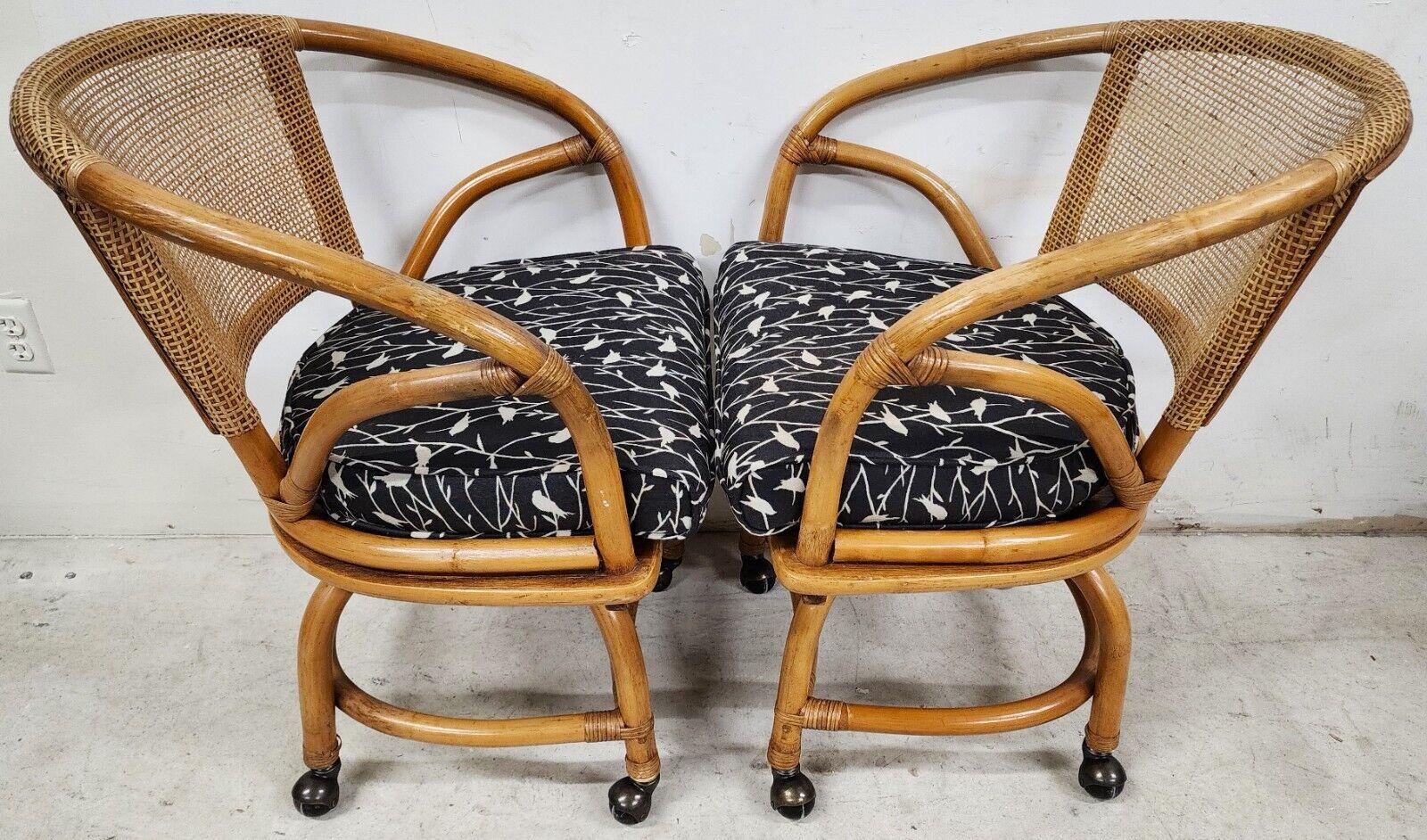 Offering One Of Our Recent Palm Beach Estate Fine Furniture Acquisitions Of A 
Set of 4 1970s Bamboo Cane Back & Rattan Dining or Game Chairs with Full 360 Degree Swivel & Rolling by FICKS REED.
Fabric on zippered cushions is Black with White