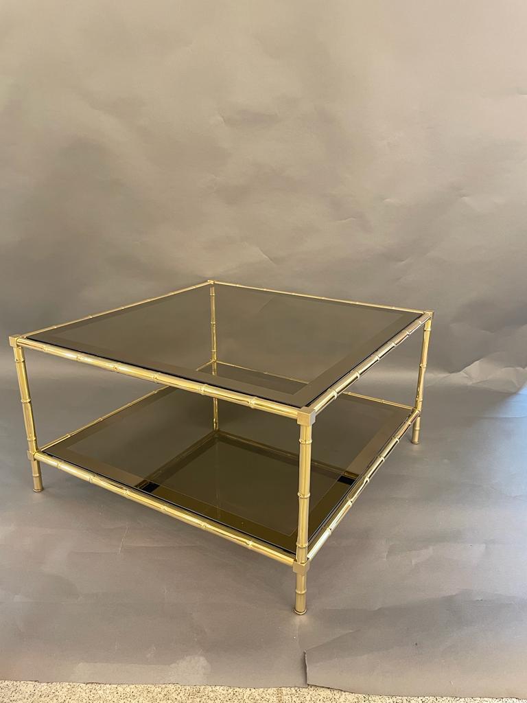 An elegant Vintage-coffee table bamboo effect with smoked glass tops and mirrored grindings. Italy, circa 1960s. 
the table it is in its original condition with the brass showing a lovely patina.