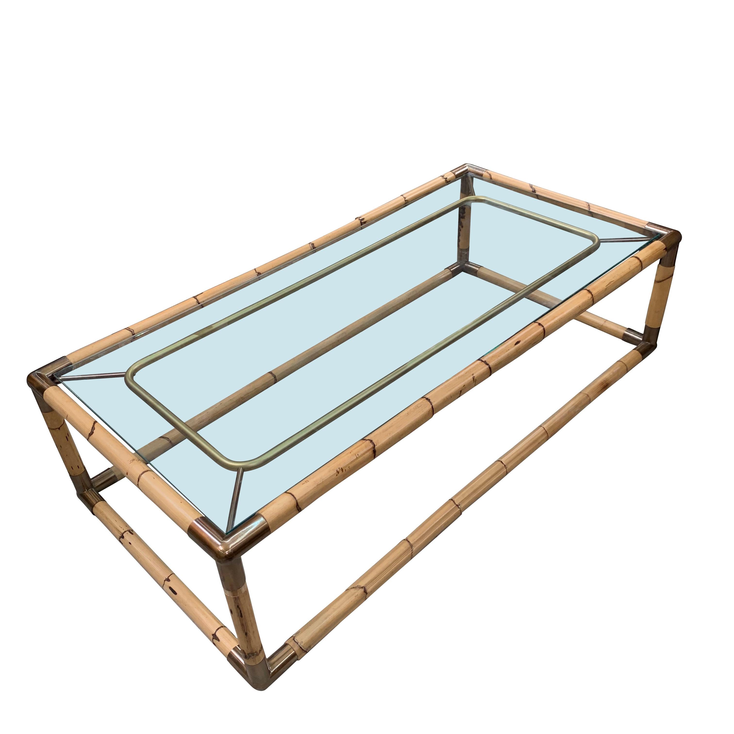 Midcentury French glass top coffee table with bamboo frame
Brass corner decorative details.
   