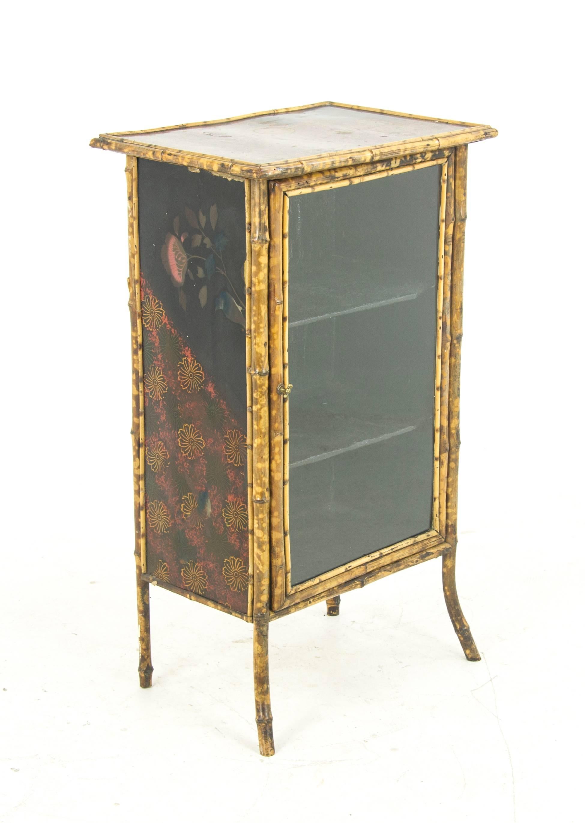 Bamboo furniture, antique display cabinet, bamboo bookcase, Scotland, 1880

Victorian bamboo display cabinet
Scotland, 1880
All original finish
Hand-painted panel on top
Single glass door below
Fitted with two fixed shelves
Ending on splayed
