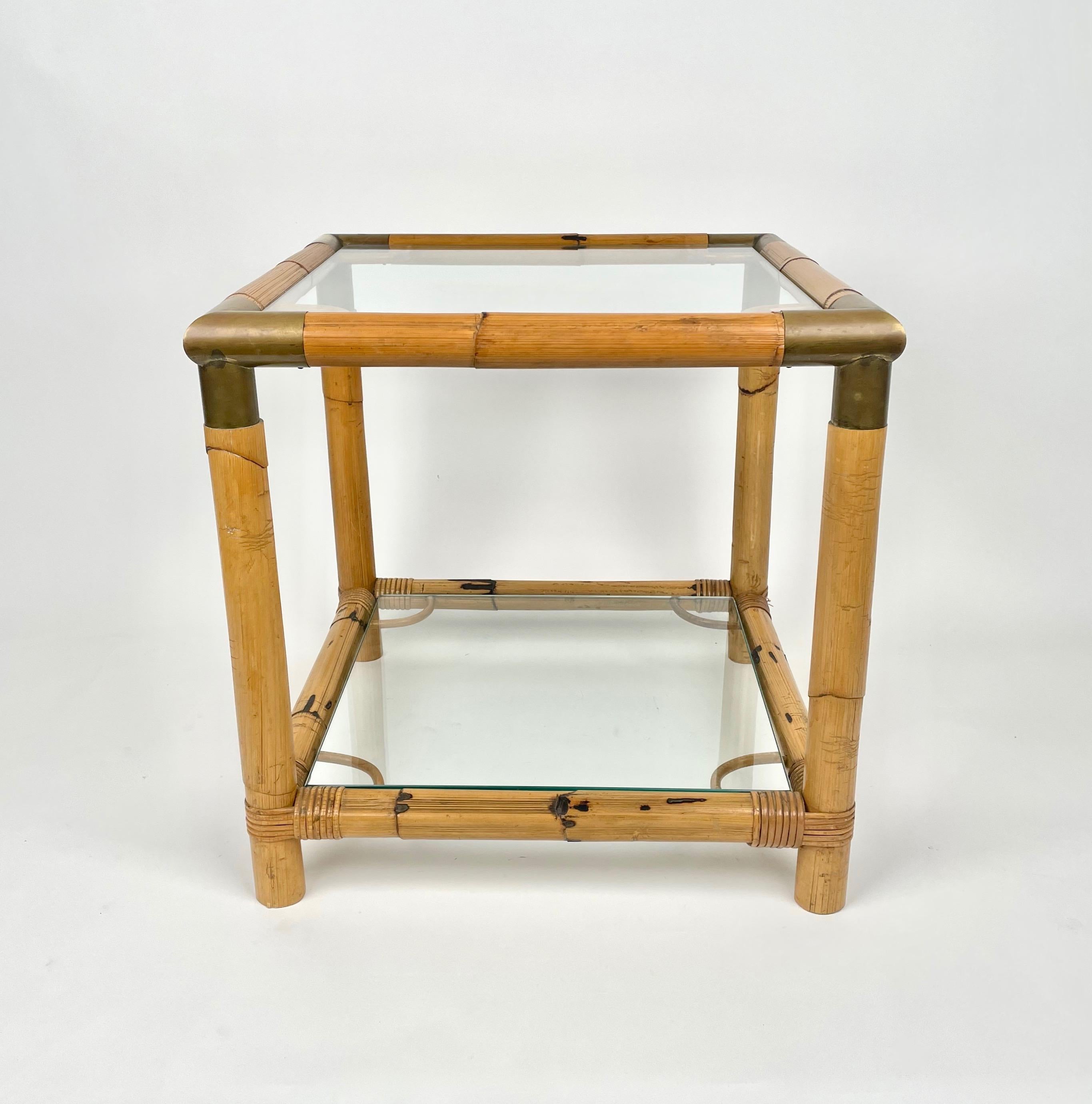 Squared side table in a bamboo structure with brass corners and two glass shelves. Made in Italy in the 1970s.