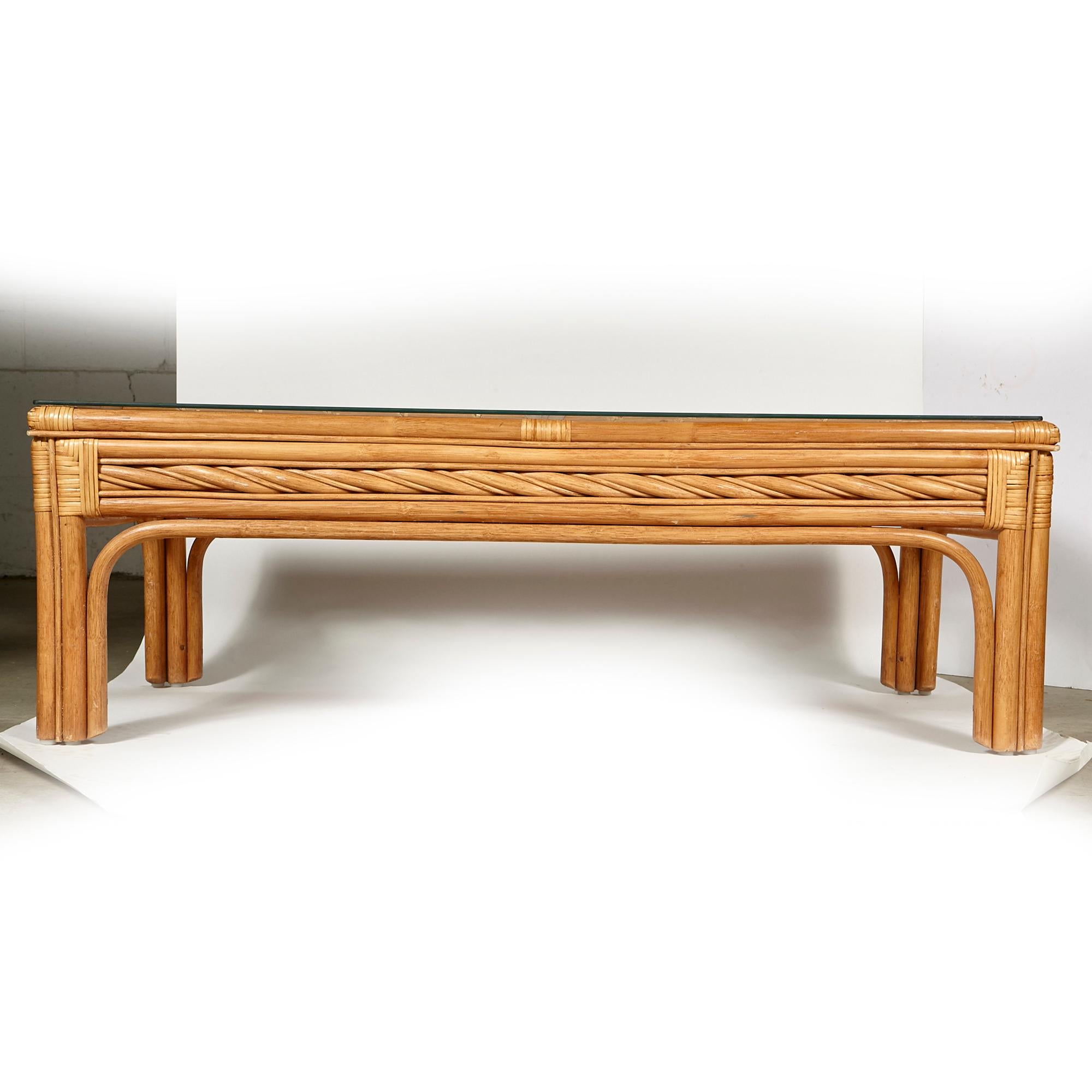 Vintage 1970s rectangular bamboo coffee table with a glass top. No maker's mark. Light wear to the glass from use.