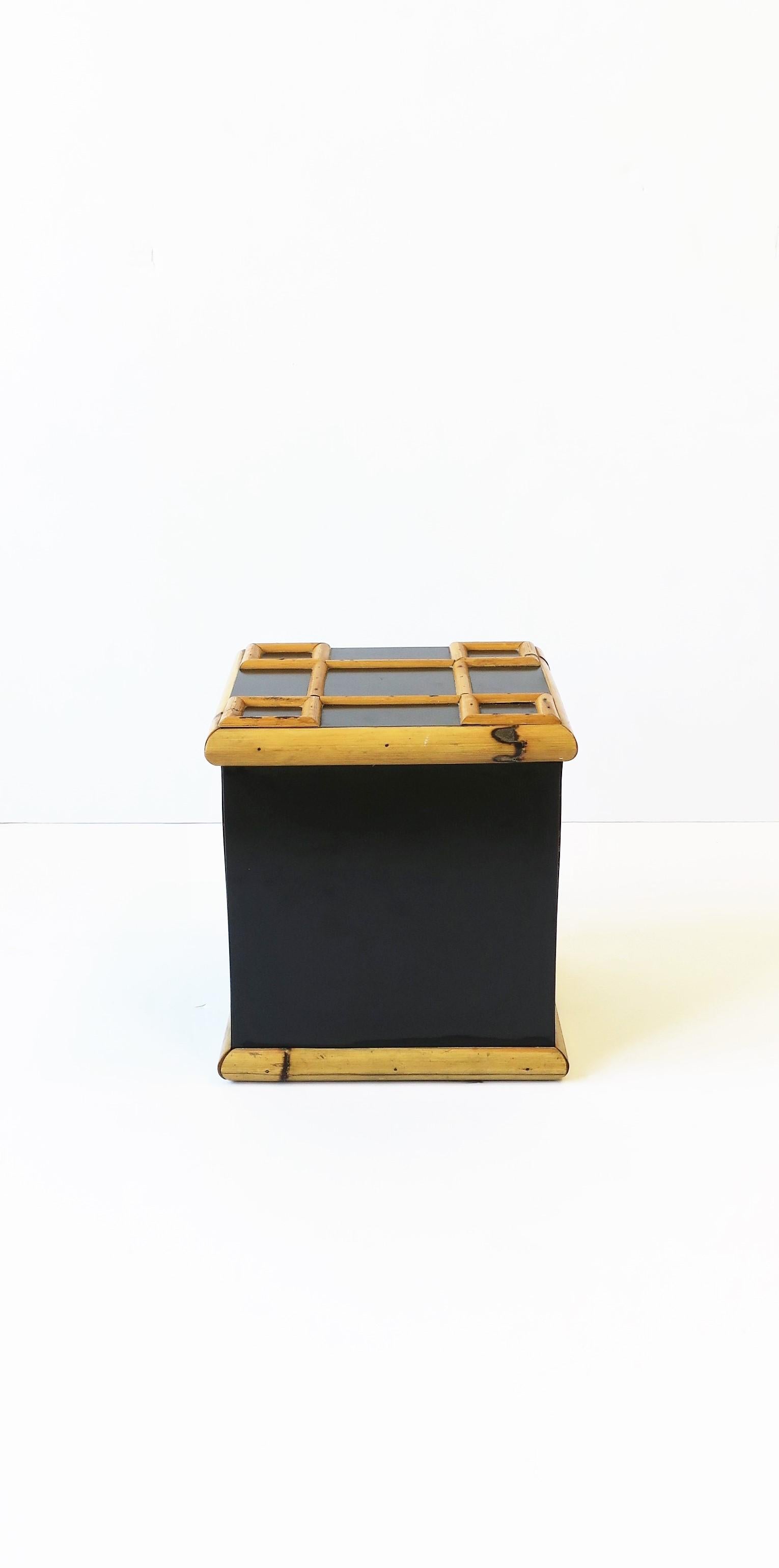 A vintage bamboo and black laminate ice bucket, circa 1960s. Piece is square with a lattice bamboo design on top/lid and a bamboo edged base. A great entertaining piece for any bar, pool house, entertaining area, etc. 

Dimensions: 8.75