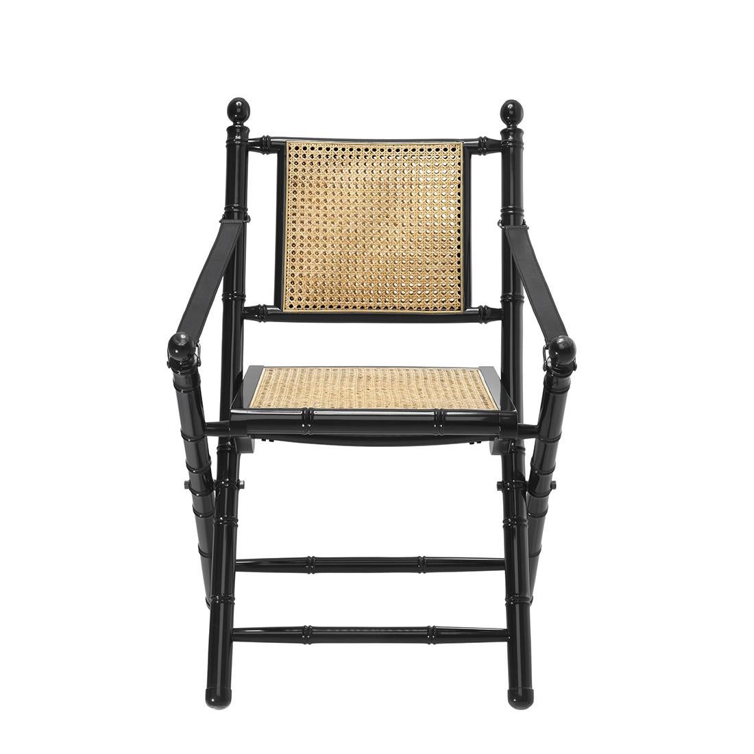 Folding chair bamboo lacquered with structure
in solid mahogany wood in black lacquered finish.
Seat and back in natural rattan. With black leather
armrest and with details in solid brass and nickel.
Also available in brown finish with structure