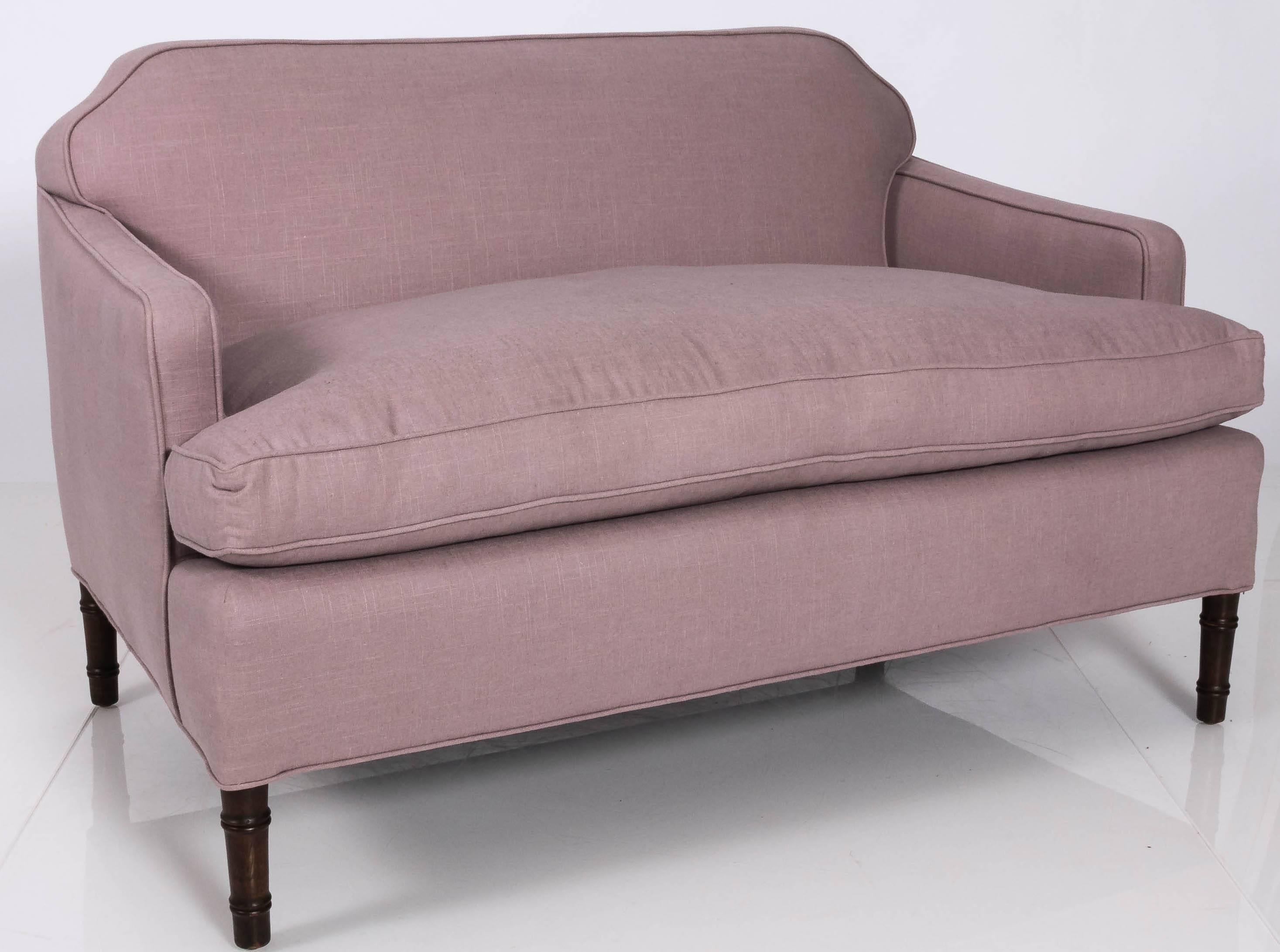 1960s newly upholstered small sofa with bamboo legs. Notched corner detailing. Down filled seat. Newly upholstered in pale purple linen by Schumacher. Seat is 22