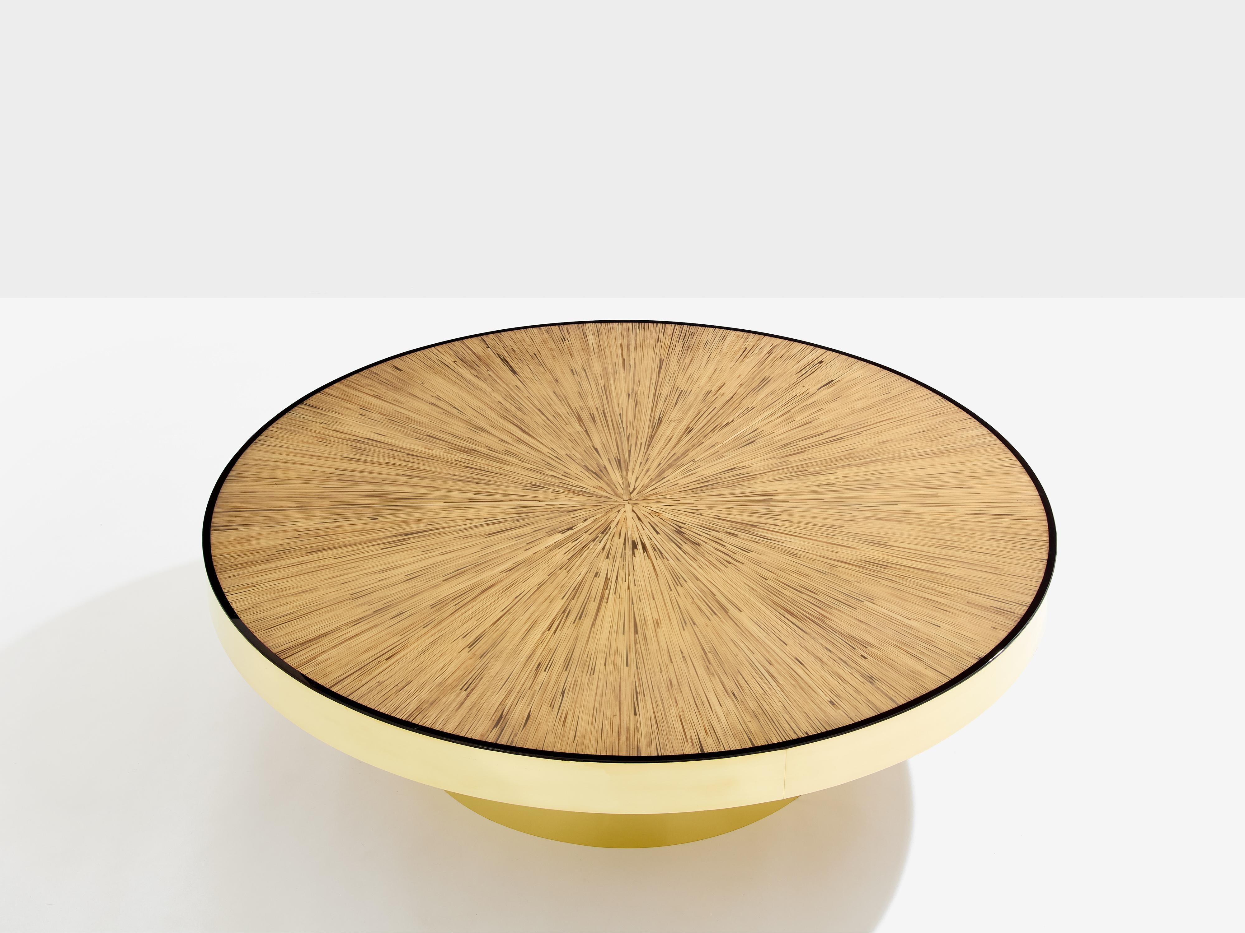 Beautiful coffee table, probably made to order by a French interior designer in the 1980s. Natural bamboo as the chief material, the patterned marquetry on the table top creates a beautiful symmetry, with an organic aesthetic, while the bright