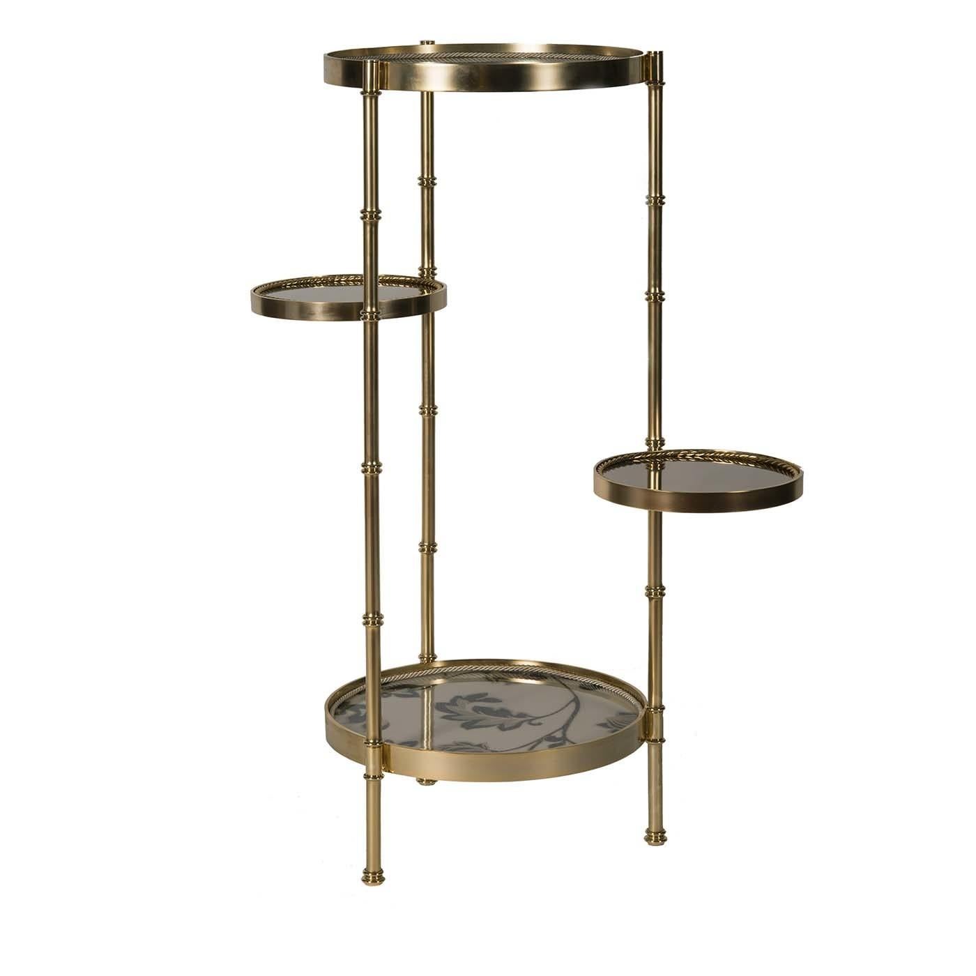 The design of this eye-catching table is a testament to modern aesthetic taste and traditional craftsmanship. Made entirely of brass with a satin gold finish, the corner table is composed of two main circular surfaces supported on three slender