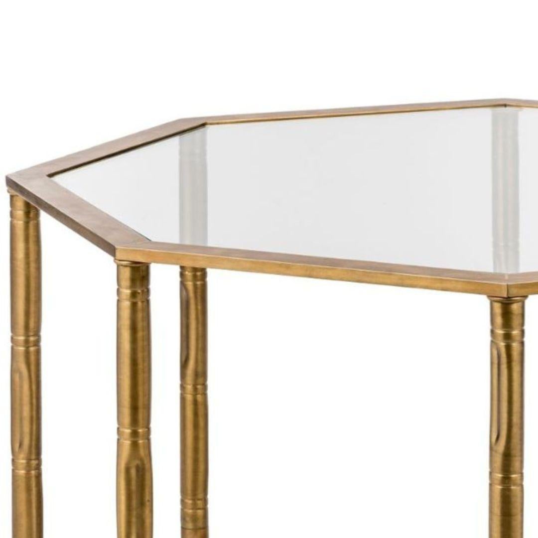 The Bamboo side table is a unique piece of furniture that combines classic brass with a touch of nature. Its sturdy legs, crafted to resemble bamboo canes, add a touch of organic charm to the piece. The tempereted glass top provides a sturdy and