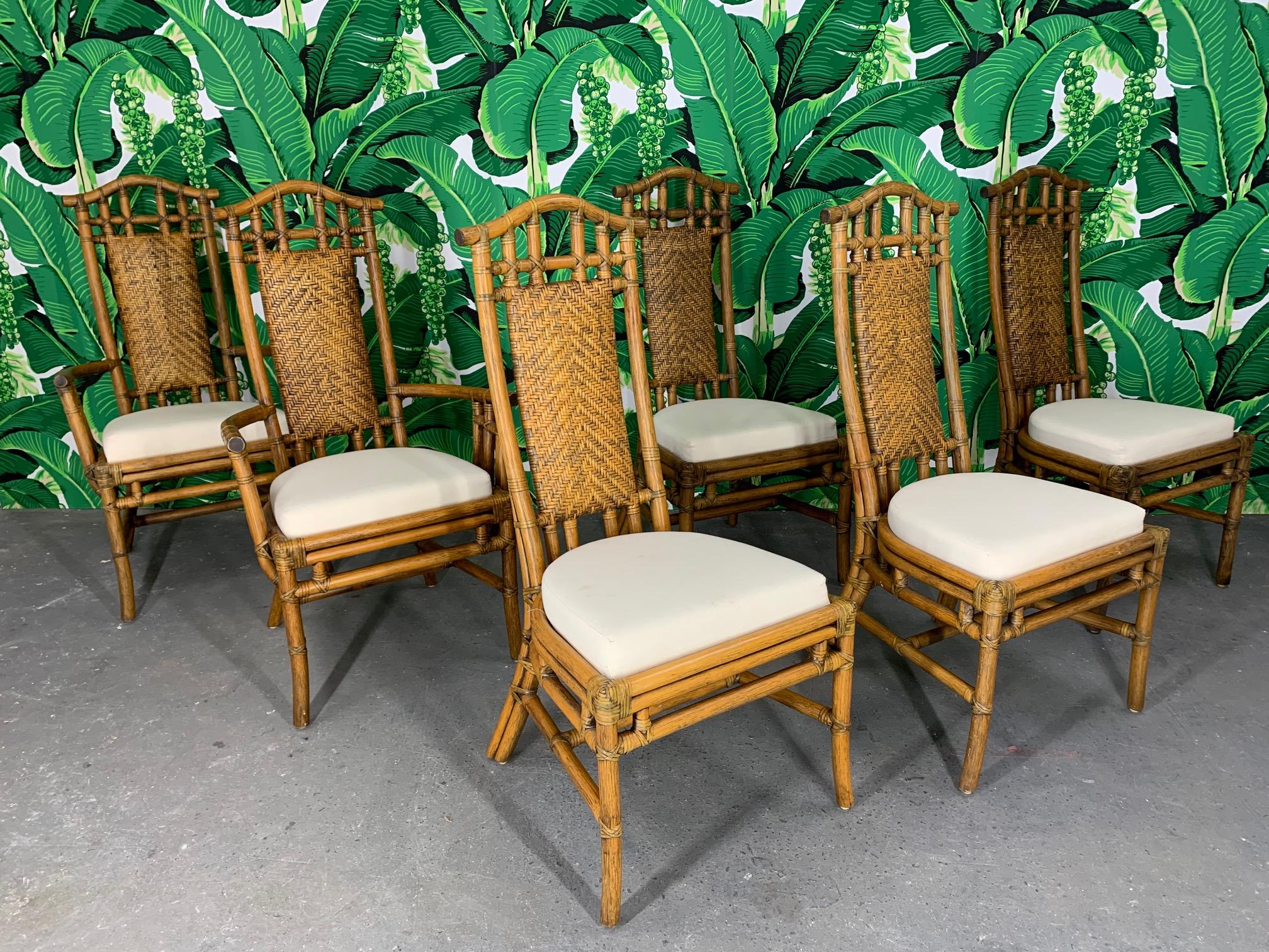 Set of 6 McGuire bamboo pagoda high back dining chairs feature woven rattan cushioned backs and upholstered seats. Very good condition with minor imperfections consistent with age. Some light staining on seats.