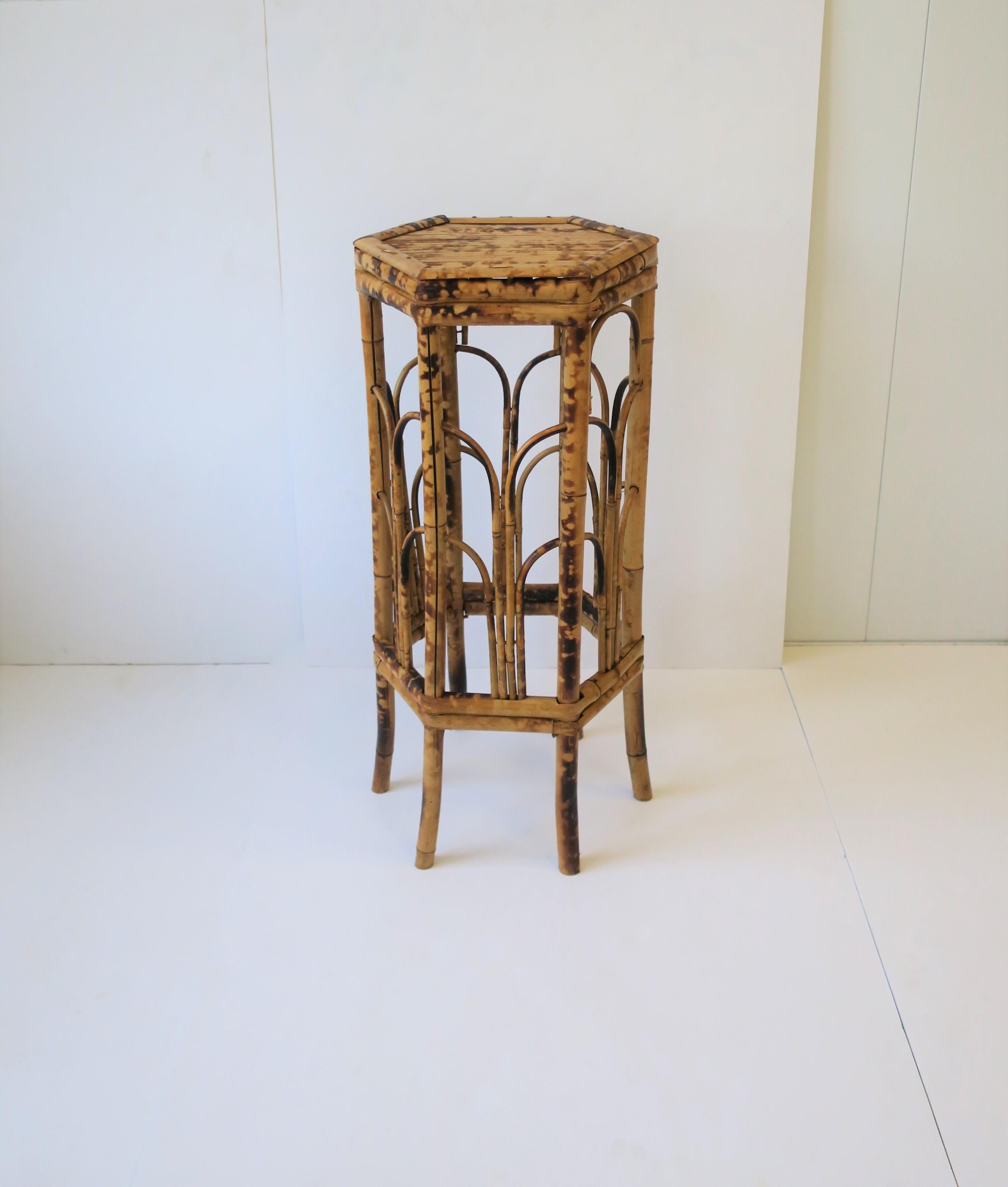 A bamboo pedestal column stand table, circa 1970s, in the Art Deco style. Table has a 'hexagon' shape, which is a nice alternative to round or square. Piece could work well as a plant Stand, or to display a sculpture, coral as shown, or other, etc.