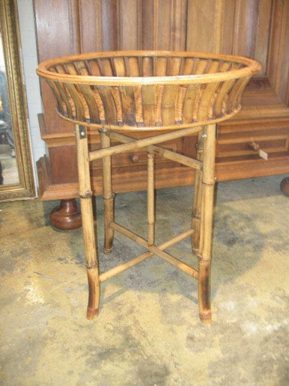 Beautifully woven bamboo basket attached to bamboo legs. Vertical bamboo slats on the basket sides. Measure: Basket is 5