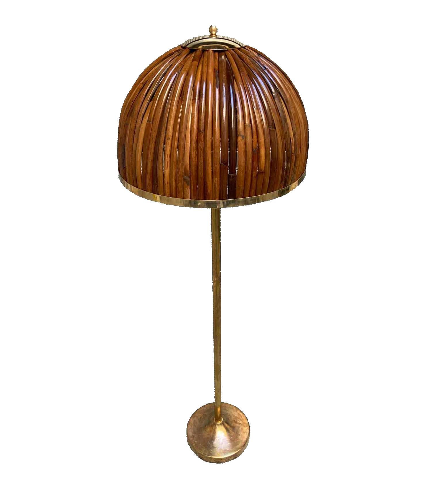 Brass and rattan floor lamp, Italy late 1990s
The floor lamp is made of brass while the domed shade is composed of many pieces of bamboo edged with a brass ring. The details are also made of brass.
 Very good condition and patina and signs of age
