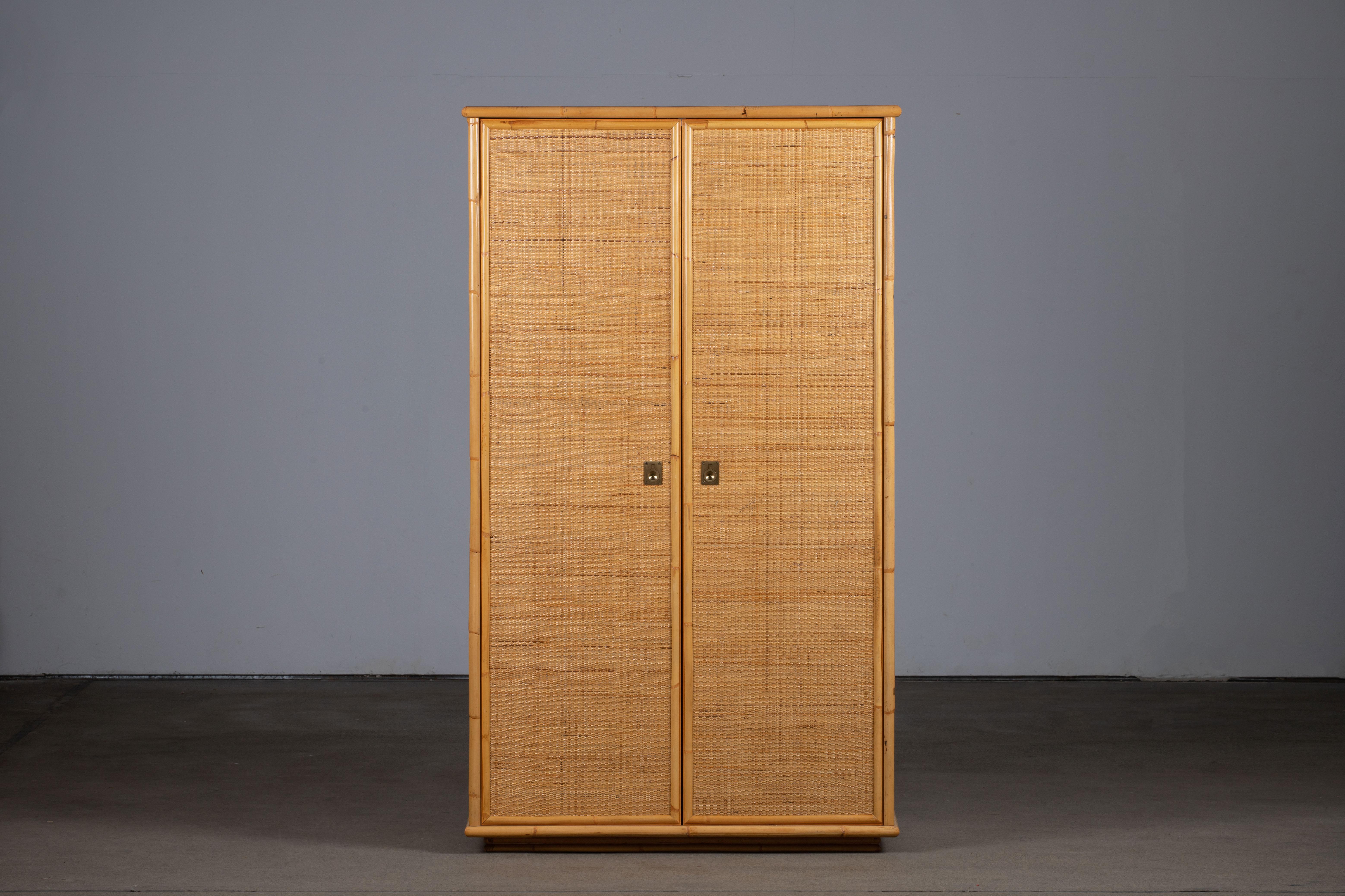 Beautiful rattan and bamboo vintage wardrobe made by Dal Vera in Italy in the 1960s. It has a double opening doors to hanging space. Brass handles complete the look. A great vintage piece in good condition which would bring a huge touch of style to