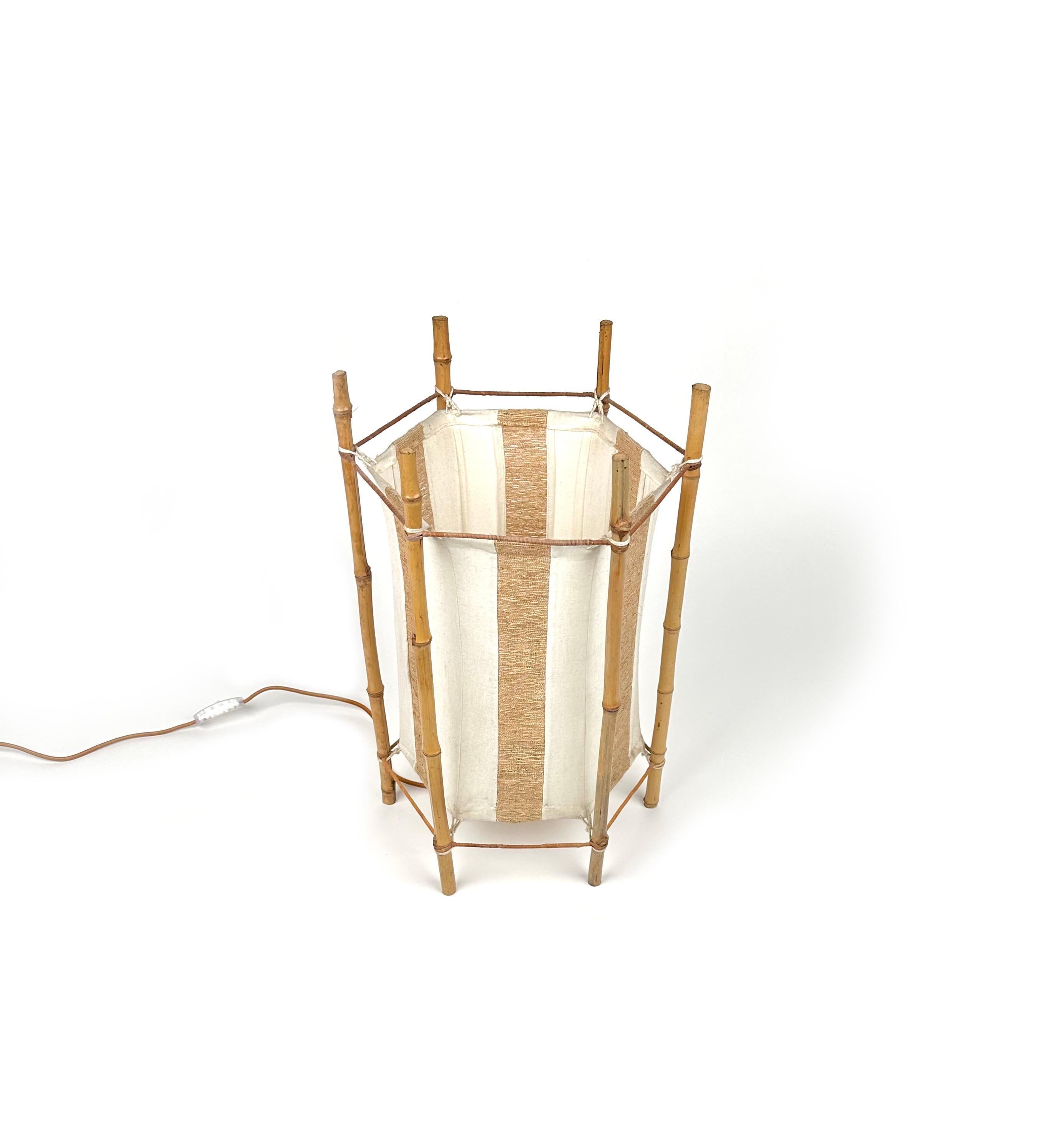 Amazing floor lamp or table lamp in white and brown cotton featuring structure in bamboo composed of six stems in the style of to the French designer Louis Sognot.

Made in Italy in the 1960s.  

Electrical system has been renewed.   

It uses 1