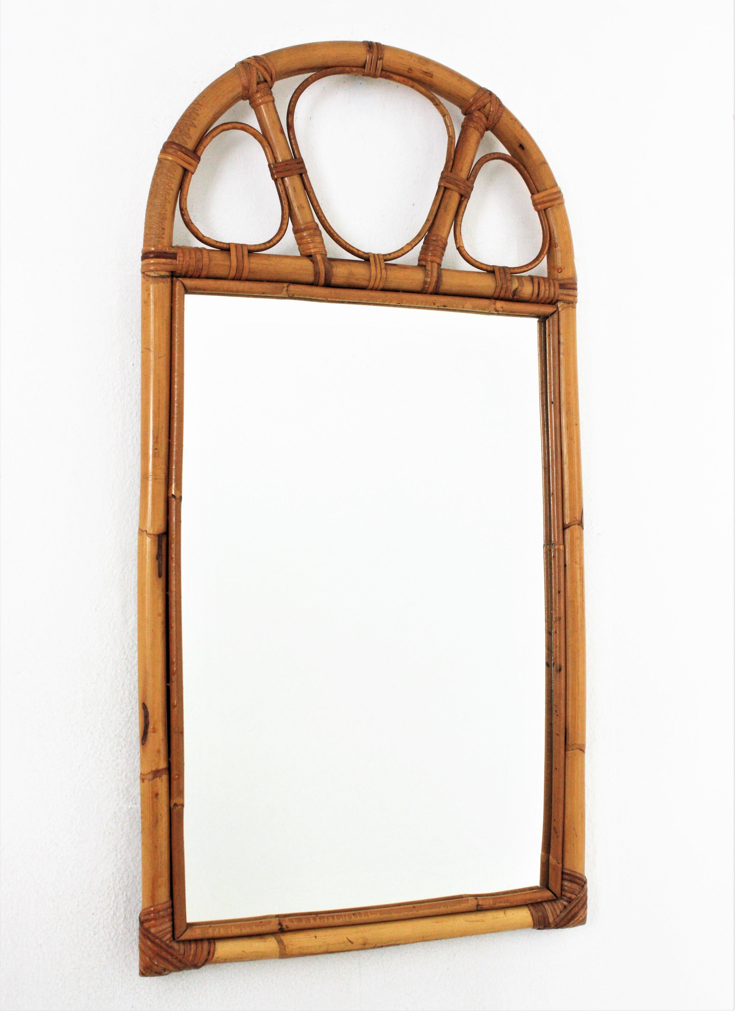 Eye-catching midcentury bamboo and rattan mirror with arched top. Spain, 1960s
This beautiful mirror was handcrafted with bamboo cane and rattan combining midcentury and oriental accents.
It will be a nice addition to be used in a bathroom or as