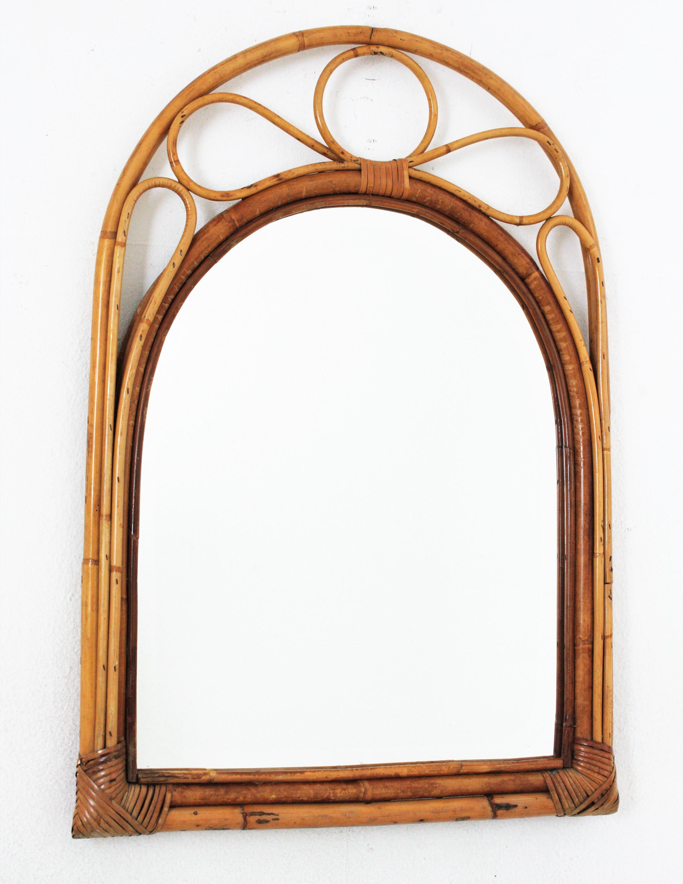 Auffälliger Spiegel aus Bambus und Rattan aus der Jahrhundertmitte mit gewölbtem Oberteil. Spanien, 1960er Jahre
Dieser schöne Spiegel wurde in Handarbeit aus Bambusrohr und Rattan gefertigt und kombiniert Midcentury- und orientalische Akzente.
Es