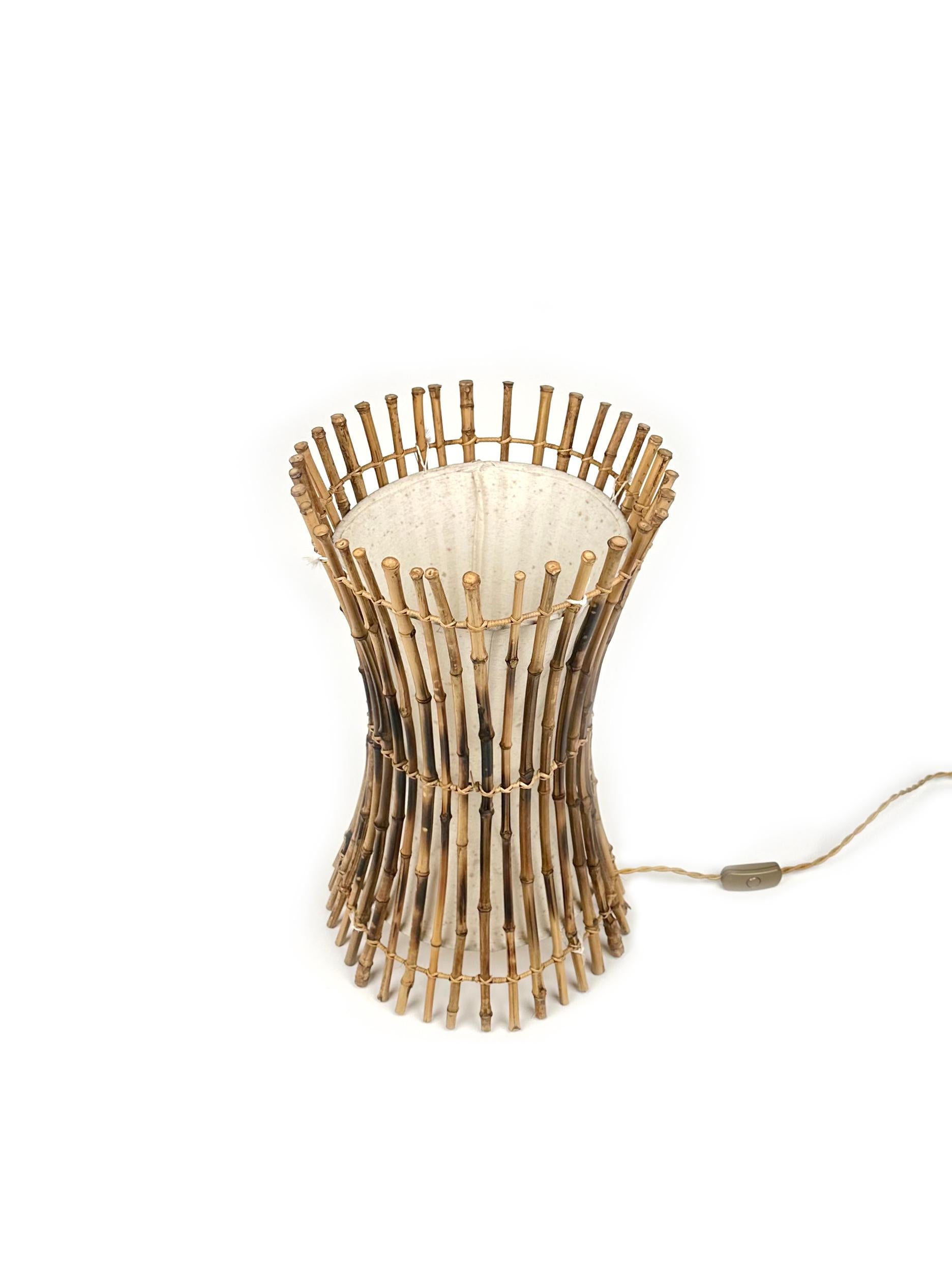 Amazing table or floor lamp in bamboo, rattan and cotton in the style of the Italian design Franco Albini.

The structure is held by rattan, bamboo and has a natural fabric original interior.

This item is perfect for a midcentury living room or