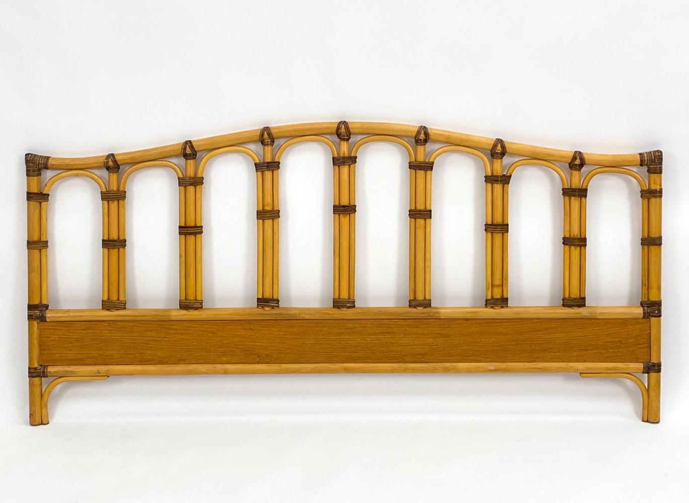 Channel the breezy tropics with this exceptional headboard and footboard set by Dux of Sweden. Constructed from genuine pole rattan, this set features a classic slatted silhouette, softened by arched intervals and a gently curved and flared crown.