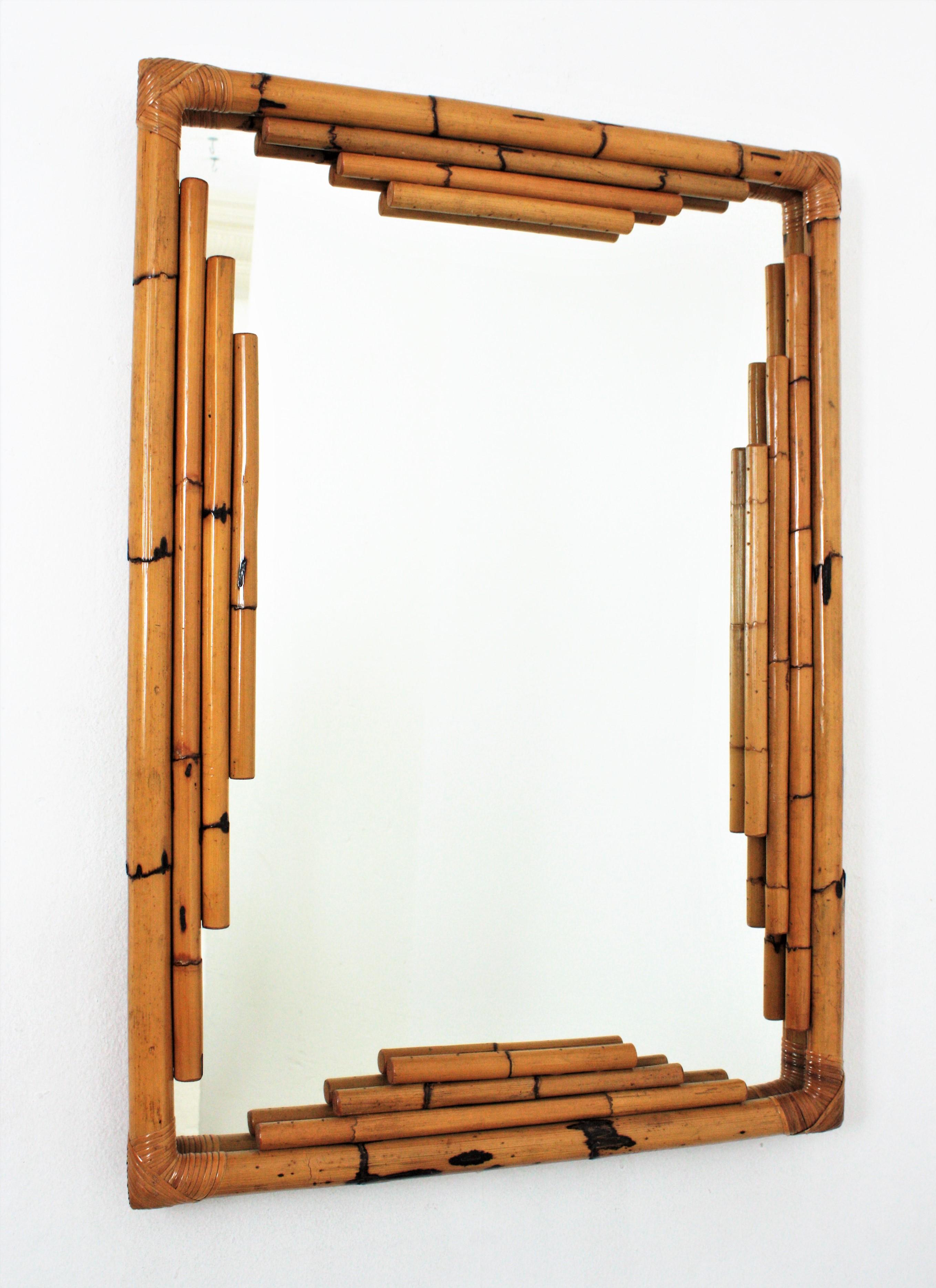 Spanish Mid-Century Modern Bamboo Chinoiserie Tiki style rectangular wall mirror. Spain, 1960s.
Gorgeous Tiki style rectangular mirror handcrafted with bamboo canes. It has a highly decorative frame with oriental inspired geometric decorations and
