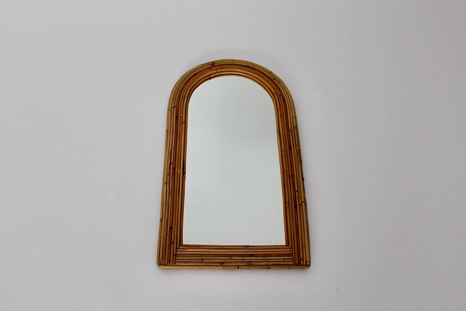 Bamboo Rattan Mid Century Modern vintage wall mirror designed 1970s France.
Beautiful shaped rattan frame with mirror glass in good condition
approx. measures:
Width 35.5
Depth 2.5 cm
Height 63.5 cm