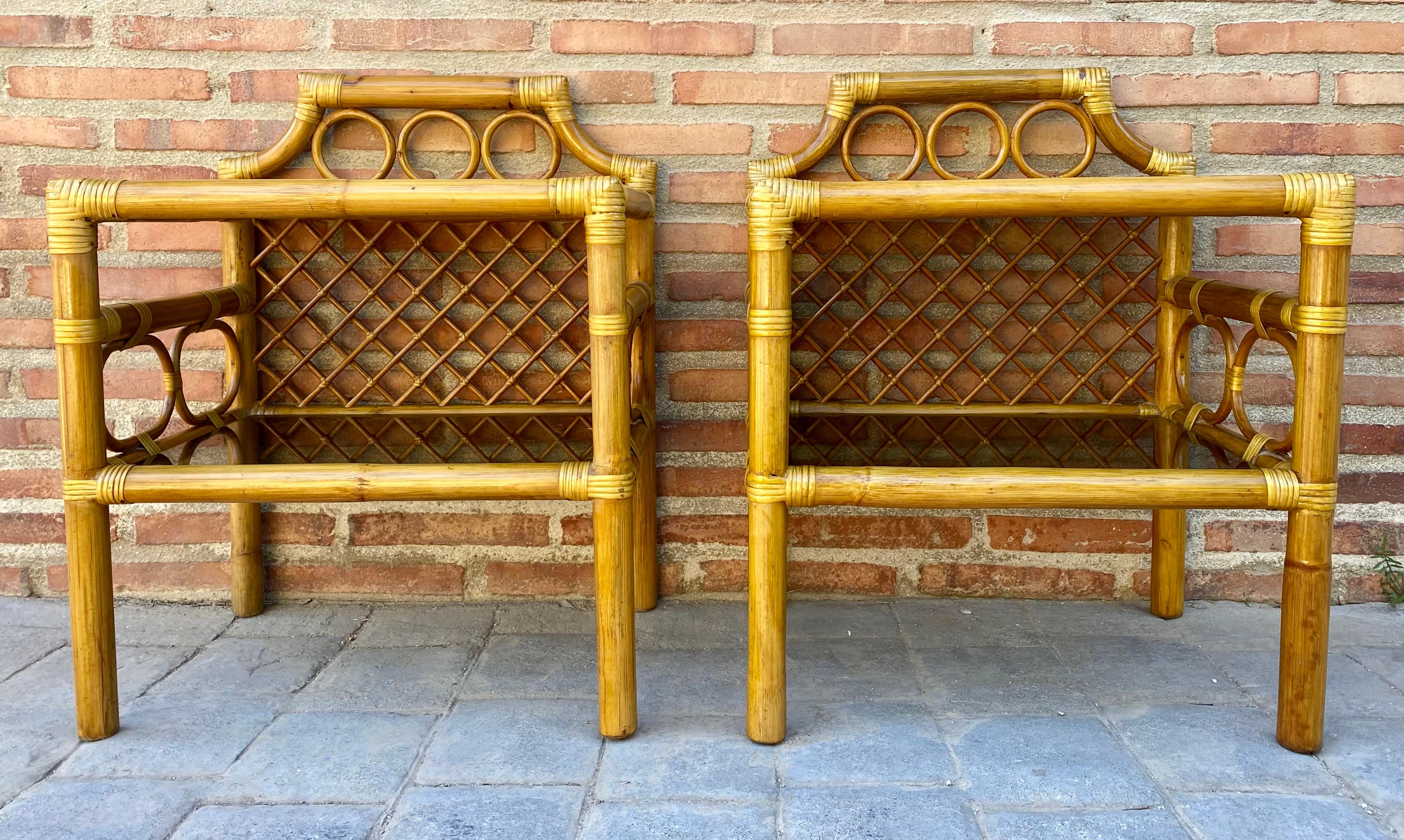 Pair of mid-century rattan and bamboo nightstands with glass base and glass low shelf. 
Rattan streamlined side nightstand with grass mat covering, edges are finished with bentwood nails. 
All rattan, bamboo and wicker furniture was carefully