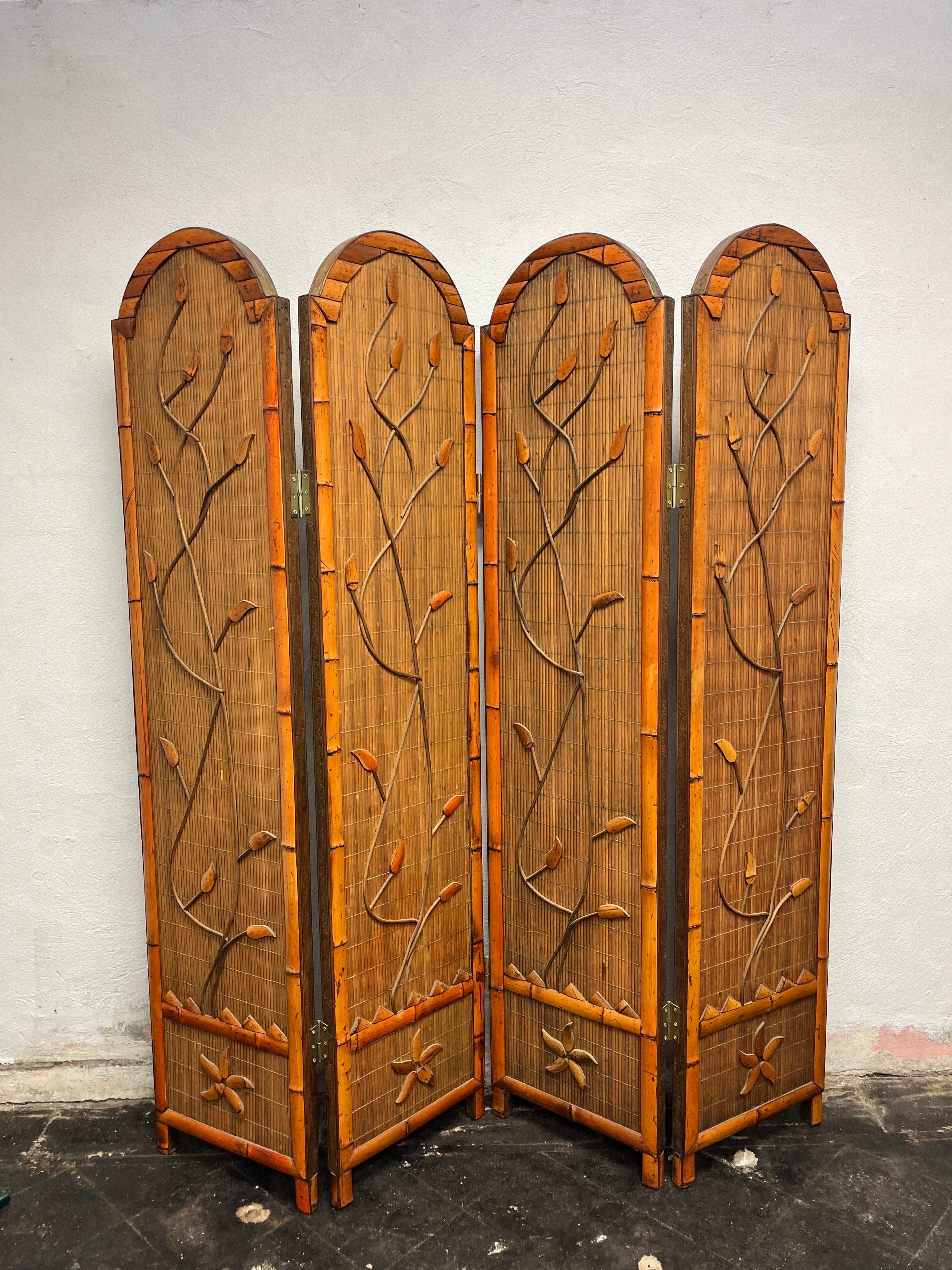 Beautiful vintage bamboo divider screen from the 1960s. Handmade with meticulous artistry, this bamboo cane room divider features a captivating 3 dimensional motif repeated pattern design on one side and woven rattan in multicolor on the other.