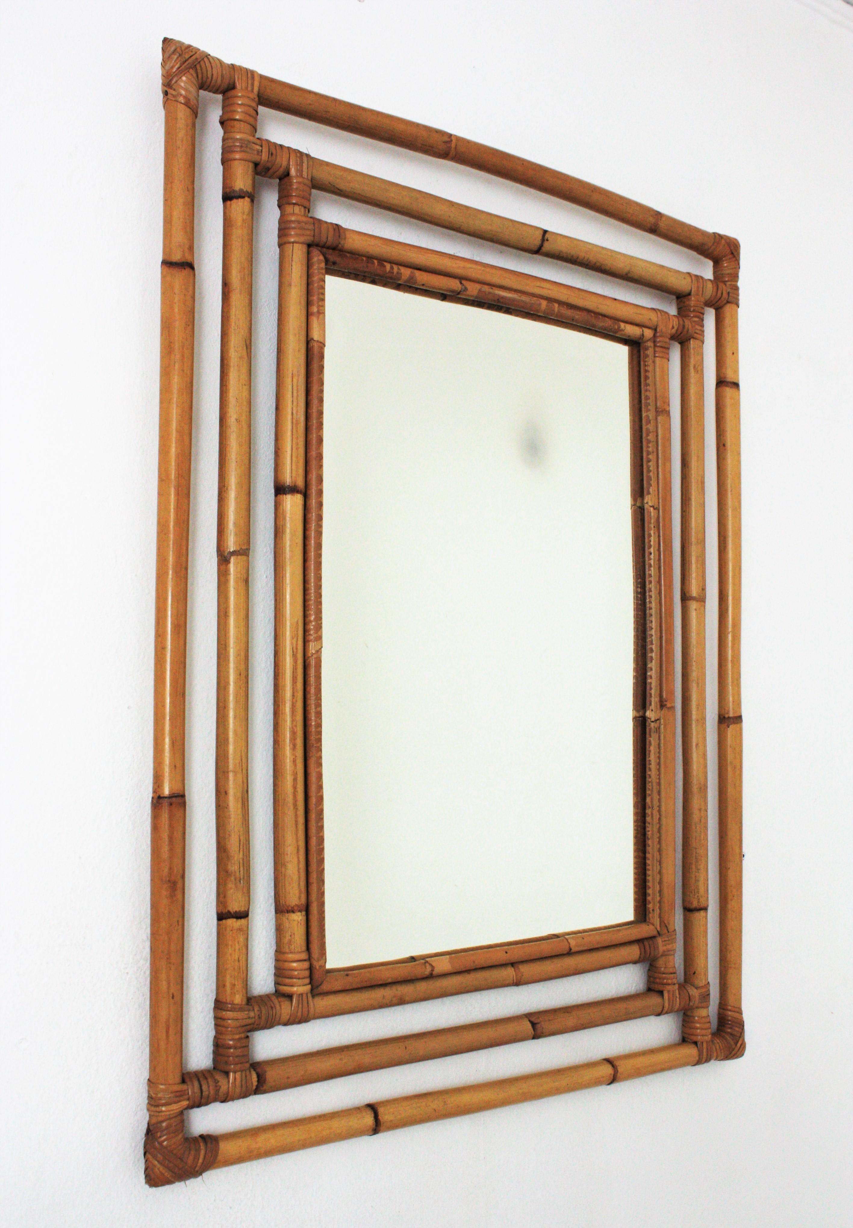Gorgeous Tiki style rectangular mirror handcrafted with bamboo cane. Spain, 1960s.
Highly decorative handcrafted bamboo frame with geometric shapes, oriental accents and a large glass surface,
This mirror is in excellent vintage