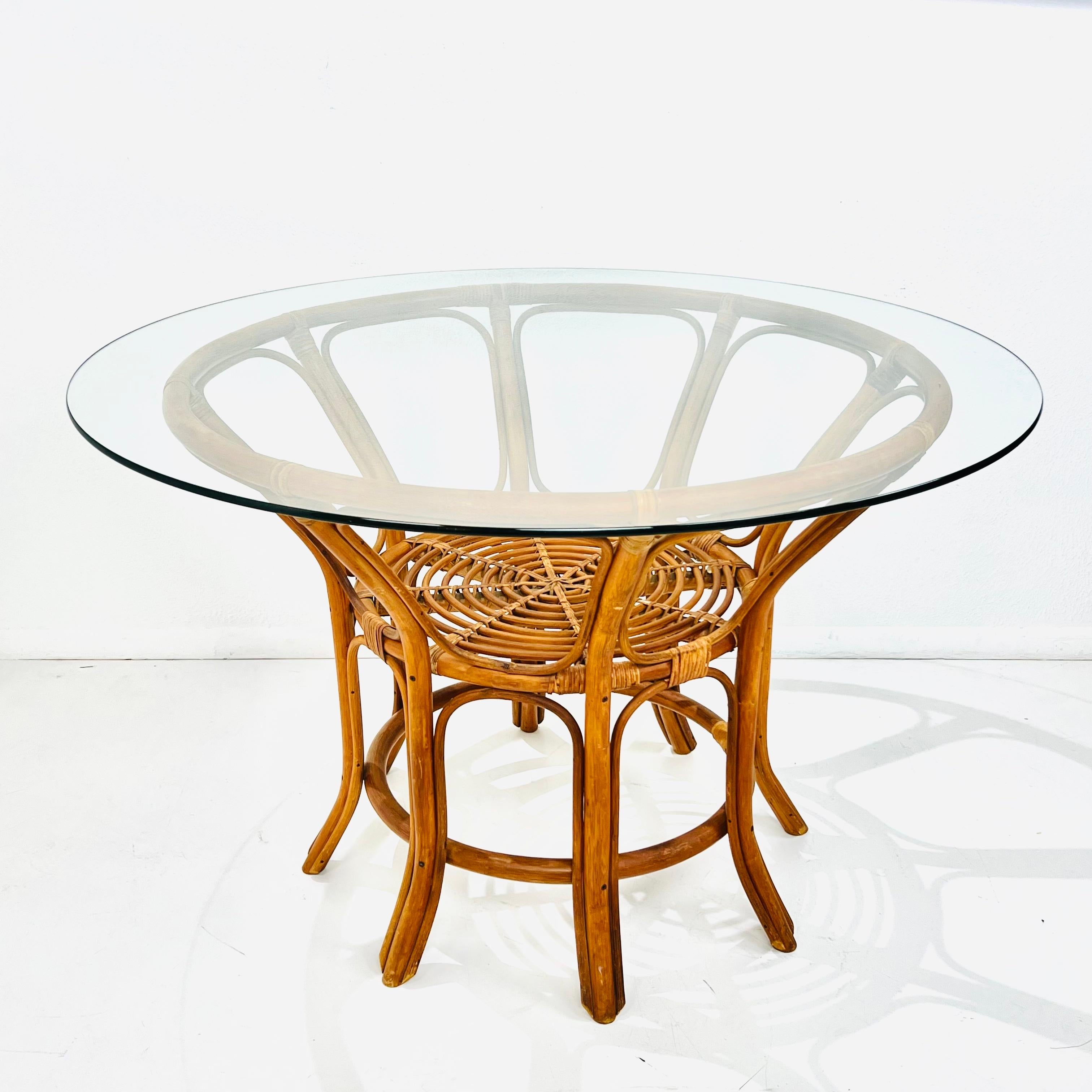 Vintage rattan coffee table in the style of Franco Albini. Original rattan finish is in good condition. There are some light scuffs and scratches consistent with age and regular use. Some of the binding on holding the base together has some wear but