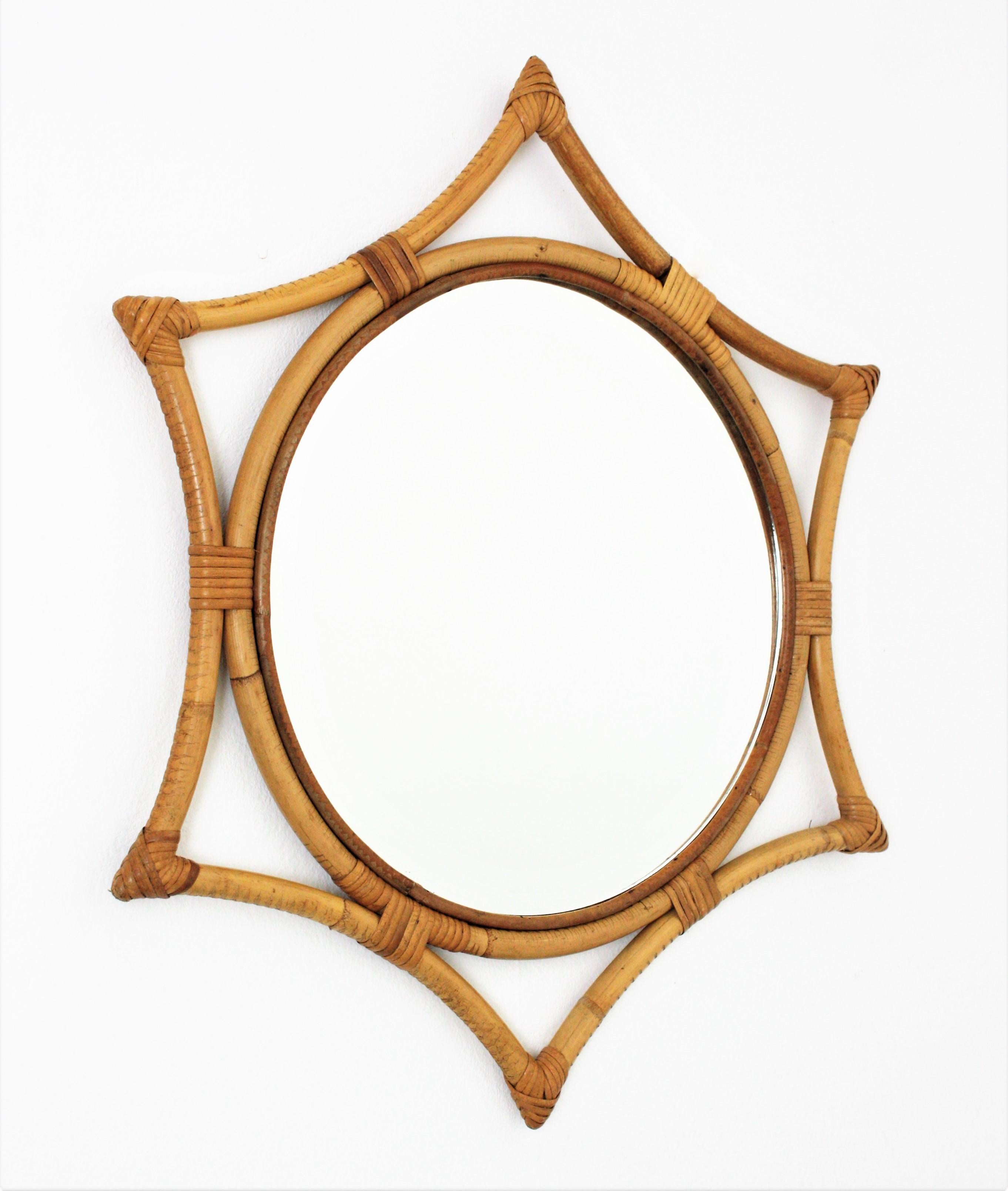 Midcentury bamboo rattan sunburst starburst mirror. Spain, 1960s.
This wall mirror features a round mirror glass framed by a bamboo star shaped frame with wicker /rattan accents.
Beautiful placed alone but also interesting as a part of a wall