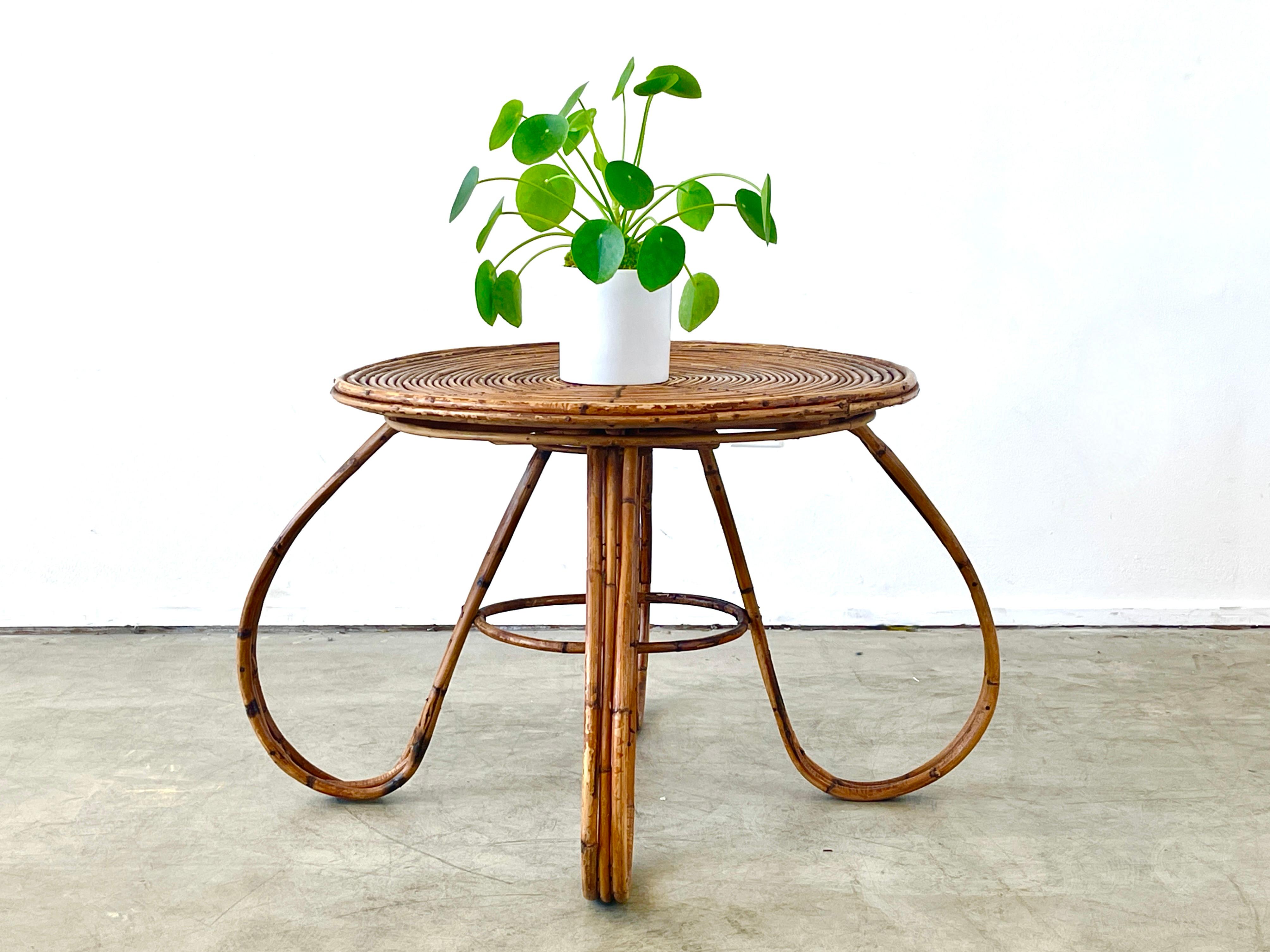 Wonderful sculptural bamboo table in the style of Tito Agnoli with large looped legs and circular round bamboo top. 

