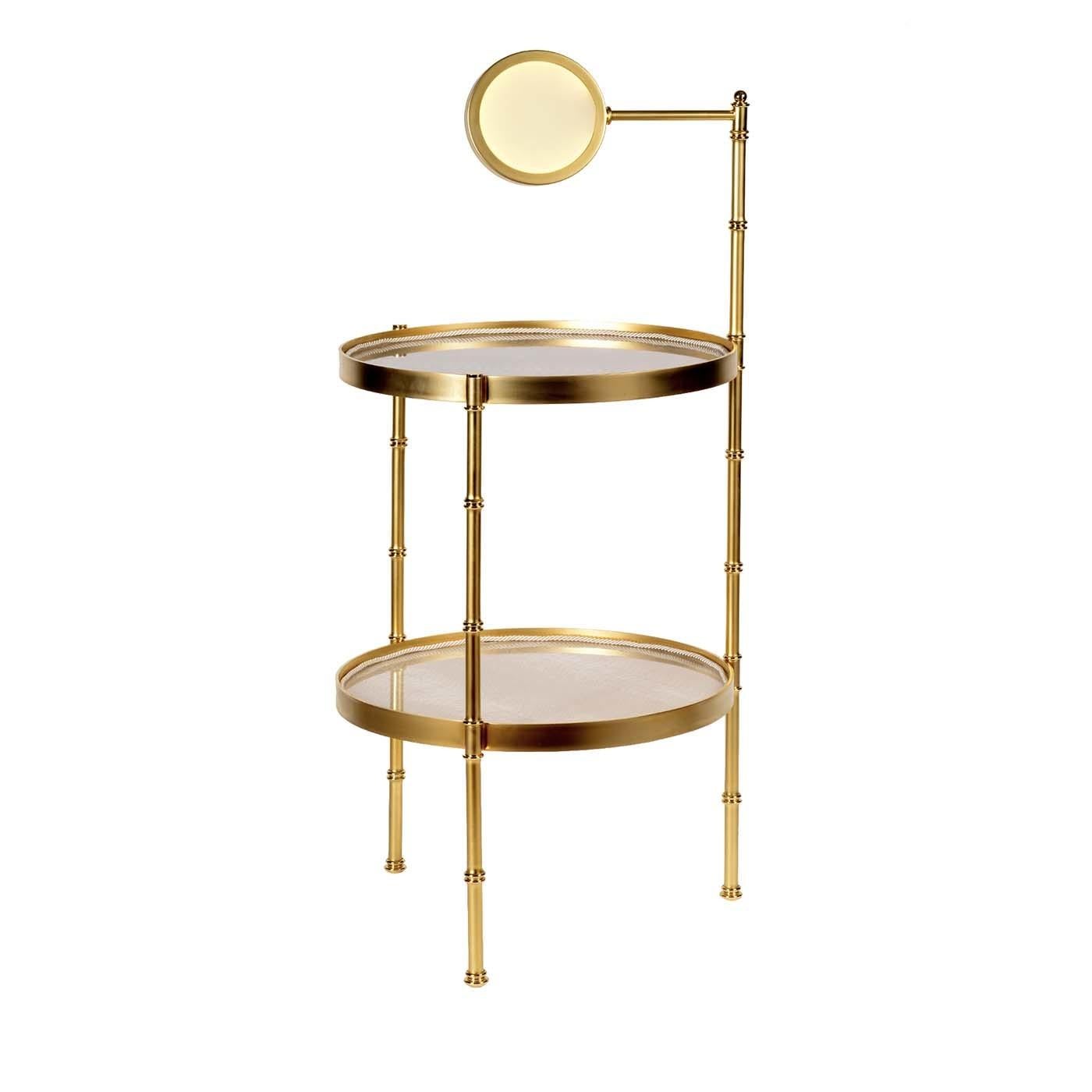 This refined coffee table will pair elegantly with a modern or Industrial interior decor. The sleek Silhouette is crafted of brass with a satin gold finish, with three tall legs supporting two circular table tops in wood with a glazed paper finish