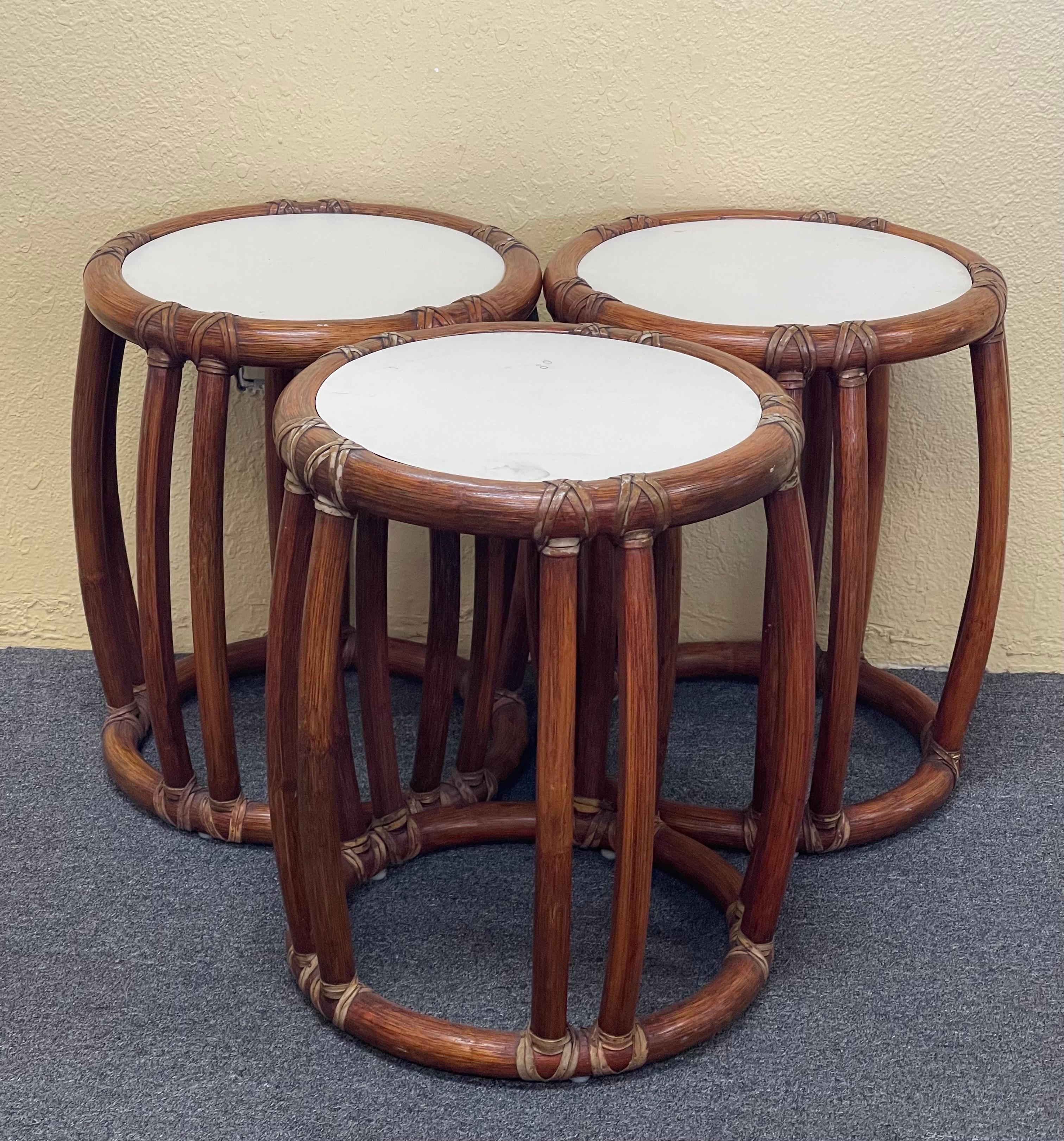 Set of three bamboo side tables / garden stools by McGuire Furniture Co. of San Francisco, circa 1970s. These tables are difficult to find and are in good vintage condition. Each one measures 14