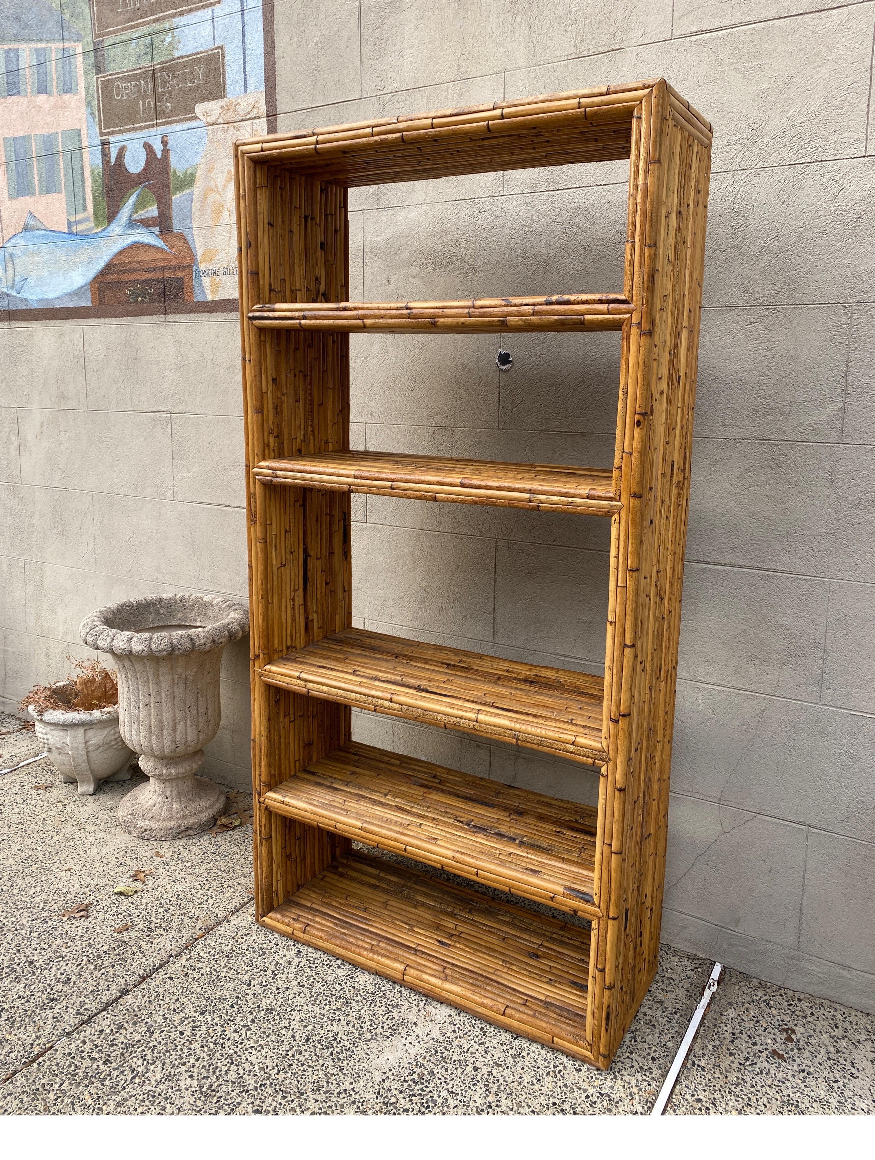 Bamboo standing etagere shelf bookcase. The six shelves and sides with split bamboo surface in a natural finish. Made in the Philippines, 1970's.