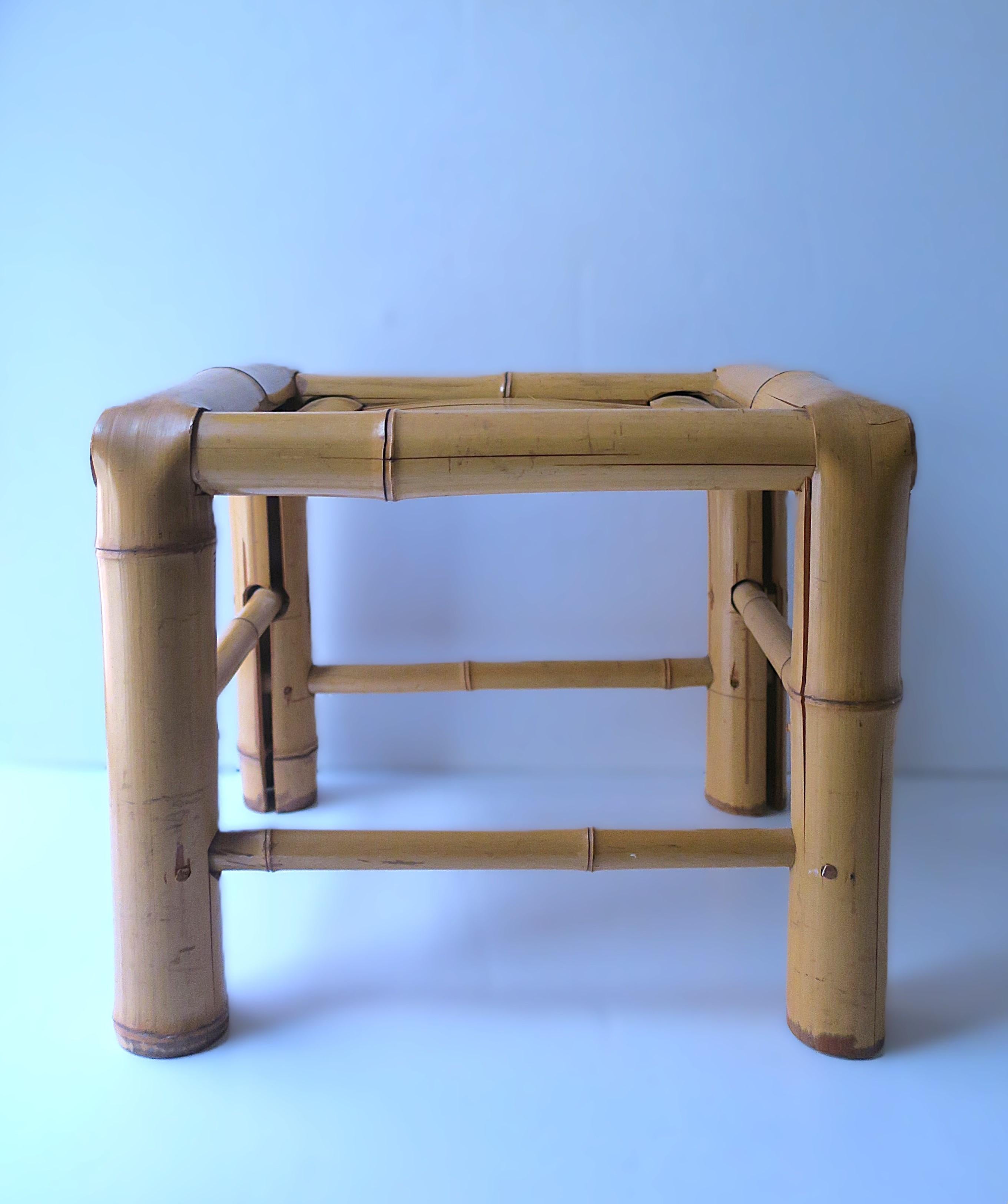 A blonde bamboo stool, circa mid-20th century, Asia. Stool is all bamboo with great bold legs; use as a low stool/seat, foot stool, as a small piece to hold a plant, books, a cocktail, etc. Many uses. Dimensions: 12.38