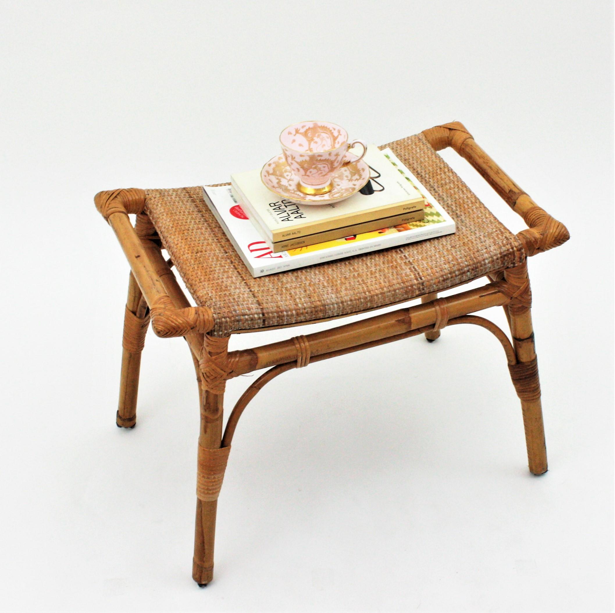 Eyecatching handcrafted bamboo and woven wicker cane stool or side table.
This Mid-Century Modernist bamboo and woven rattan / wicker rectangular stool or small bench was handcrafted in Spain near 1960s.
Design with handles at both sides inspired