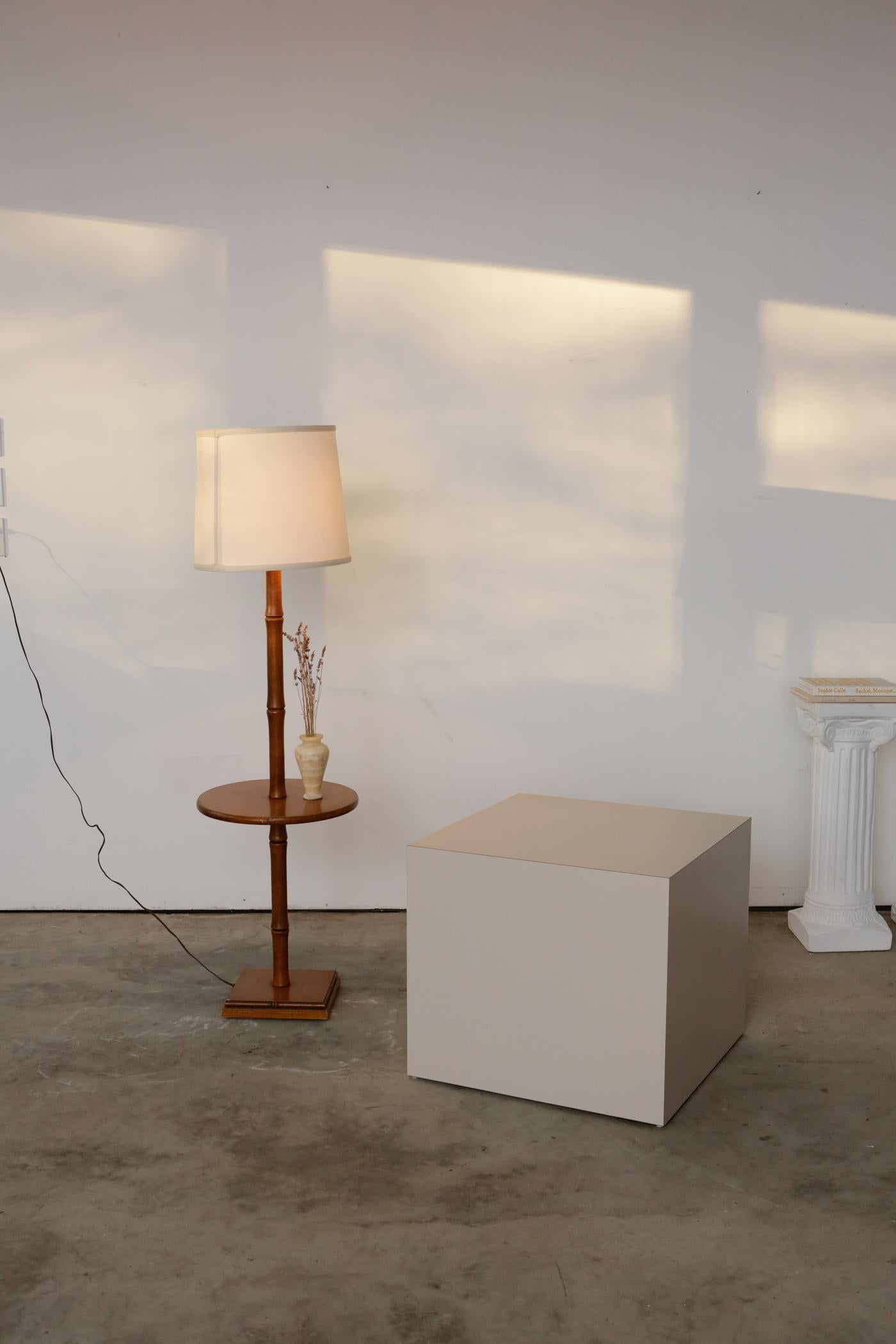 Bamboo-style standing table lamp. Light-colored wood with bamboo-styled neck and a circular shelf. Easygoing and easy to pair with any of your favorite chairs.

Measures: H57”
W 16.25” round.
 