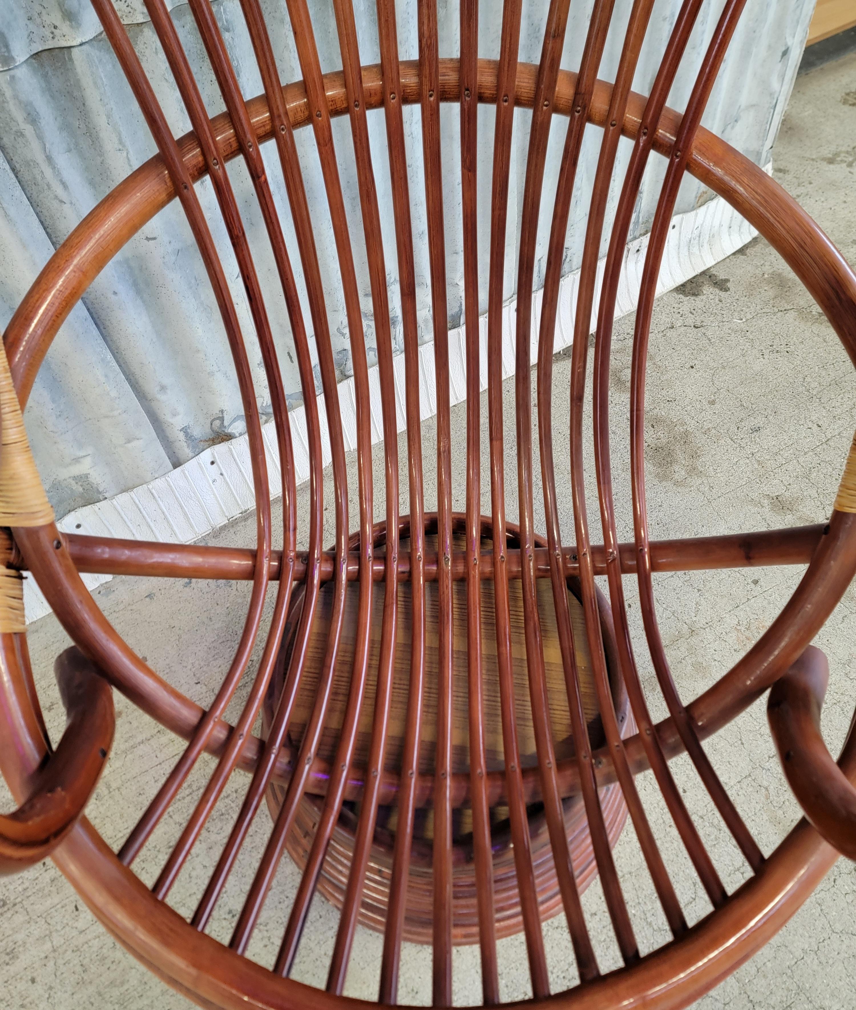 A 1970's bamboo swivel lounge chair with original removable cushion. Excellent original vintage condition. High-back measures 43 inches. Classic, comfort and condition. Swivels, does not tilt or recline. We also have a pair of accompanying foot