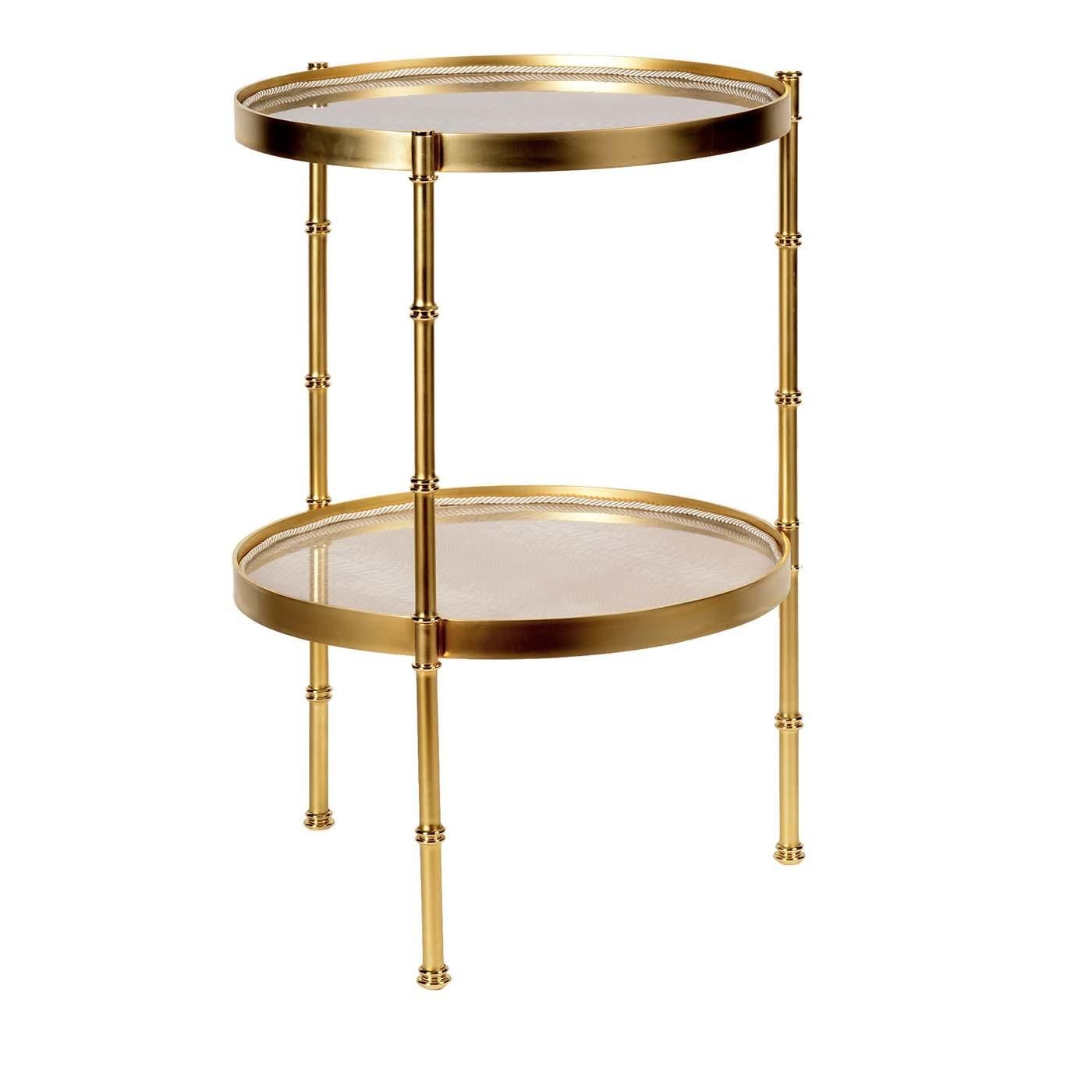 Defined by a streamlined silhouette and skilled woodworking craftsmanship, this stunning tea table will add a touch of sophistication to a living room or lounge decor. The open frame is handcrafted of brass with a satin gold finish and features