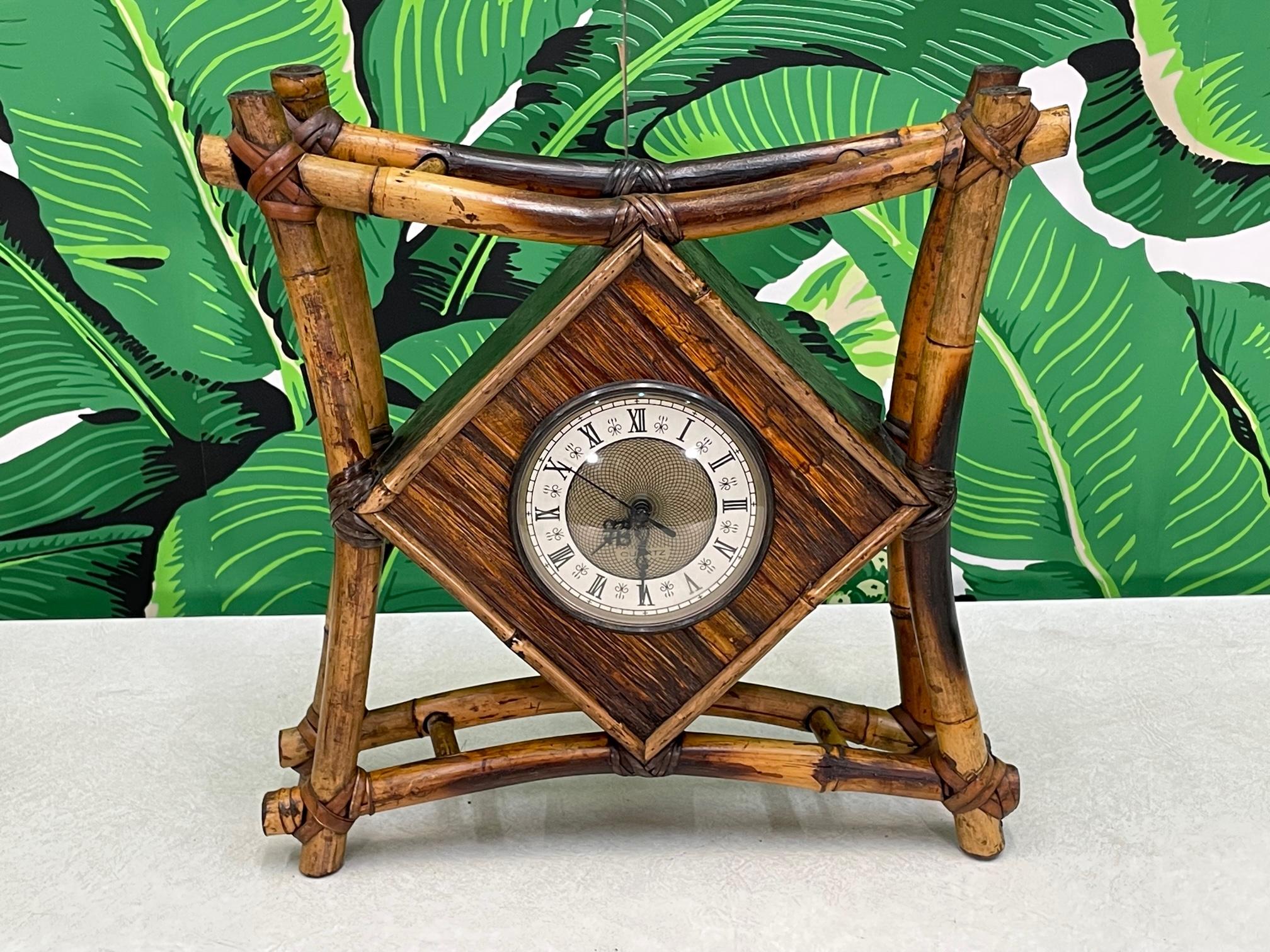 Tiki style wall or desk clock features a rattan (solid bamboo) frame lashed with leather bindings. Battery operated, takes one AA battery. Good condition with minor imperfections consistent with age, see photos for condition details.

