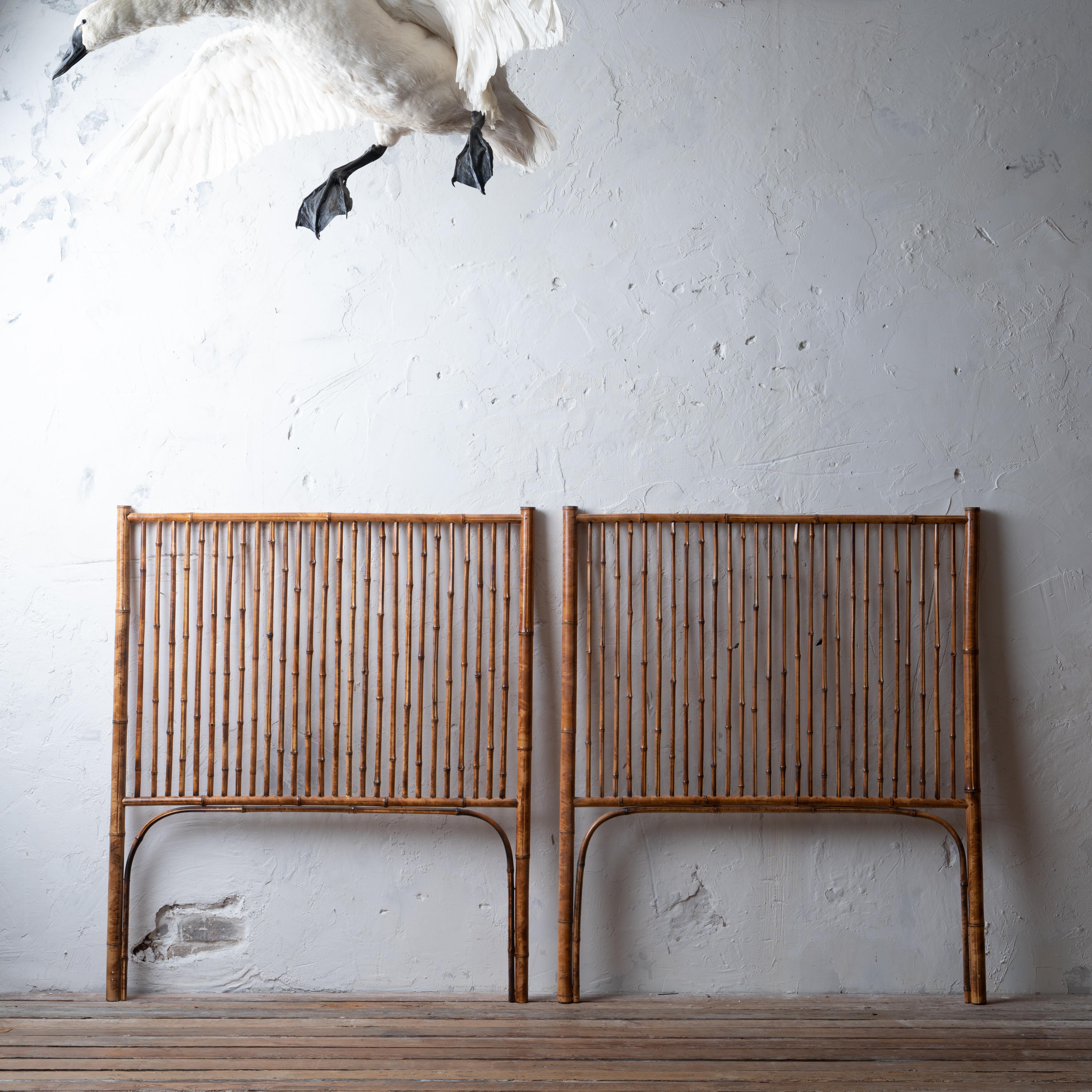 A vintage pair of bamboo twin headboards.

39 ¼ inches wide by 46 inches tall by 1 ½ inches deep

