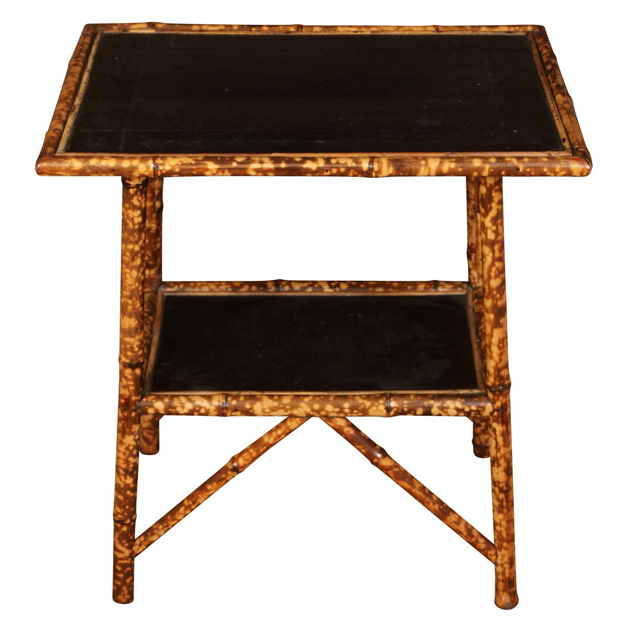 This charming bamboo side  table is a great way to add some interest to a room.  The tabletop and lower shelf are covered in black leather with a Greek key design.   This  little piece would work as a side table, bedside table, in an office,