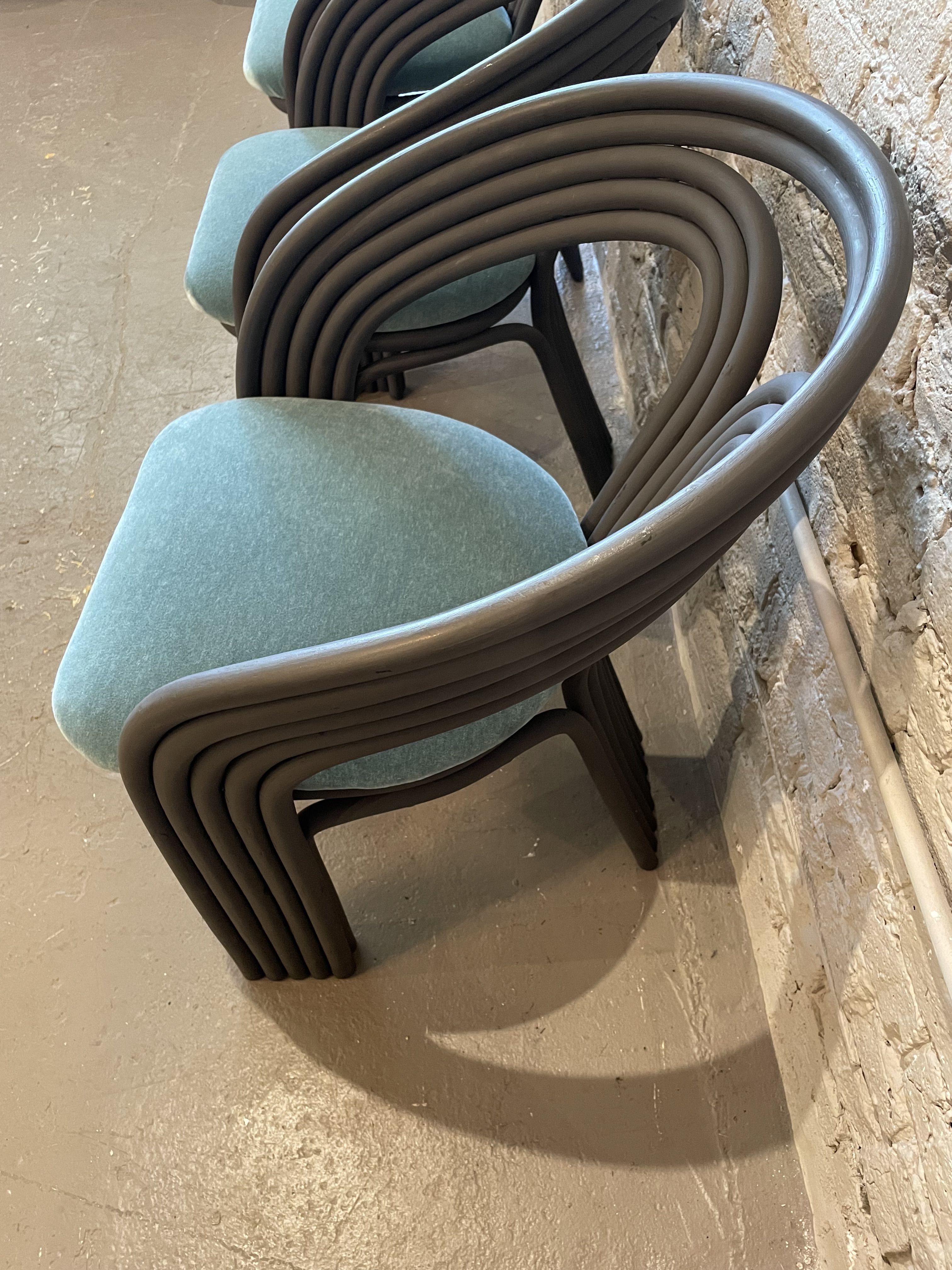 Beautiful curves! Please note - a designer borrowed these for a show and painted over the already black bamboo but the paint is peeling. I suggest sanding them and repainting/refinishing. The fabric seats are in great condition and easily removable.
