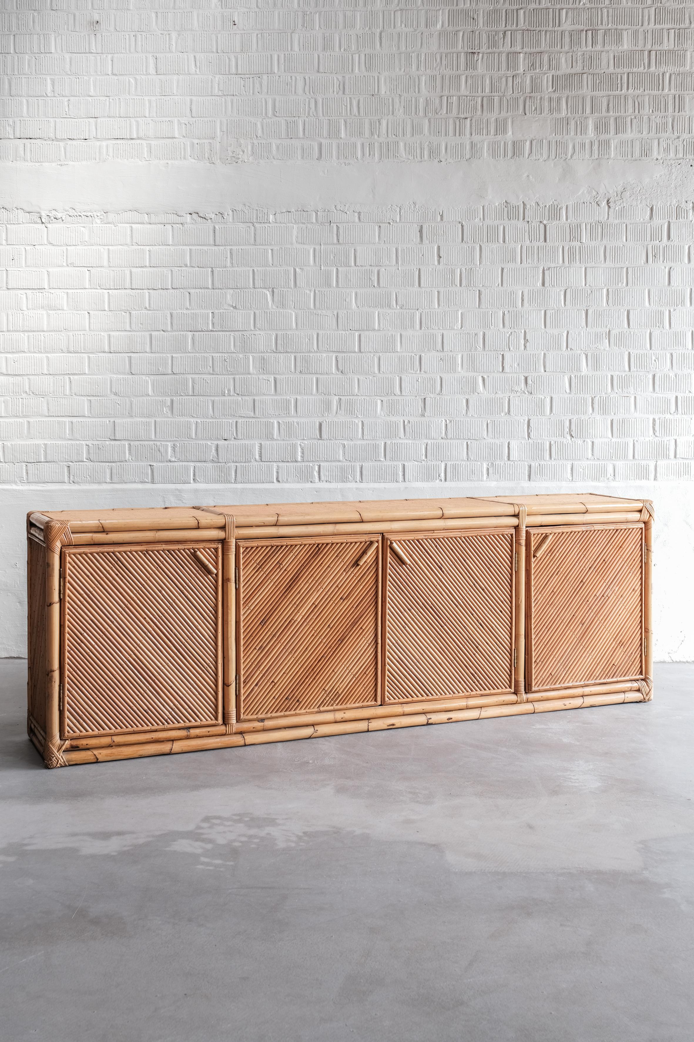 This large bamboo cabinet is 240 cm long and is in overal good condition. 
Unique model, original from the 70ties. 


