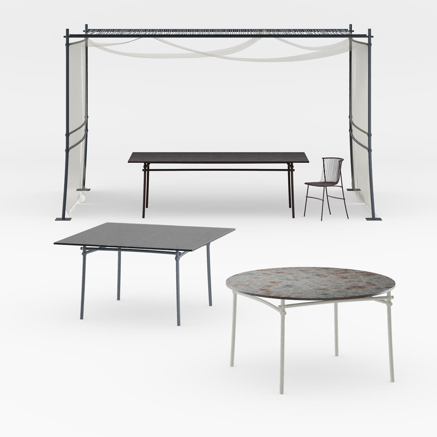Exuding a timeless industrial-chic flair, this rectangular dining table will be ideally combined with the gazebo and other furniture from the Bambusae series. Designed in collaboration with Zanellato/Bortotto, it is handcrafted of lacquered and